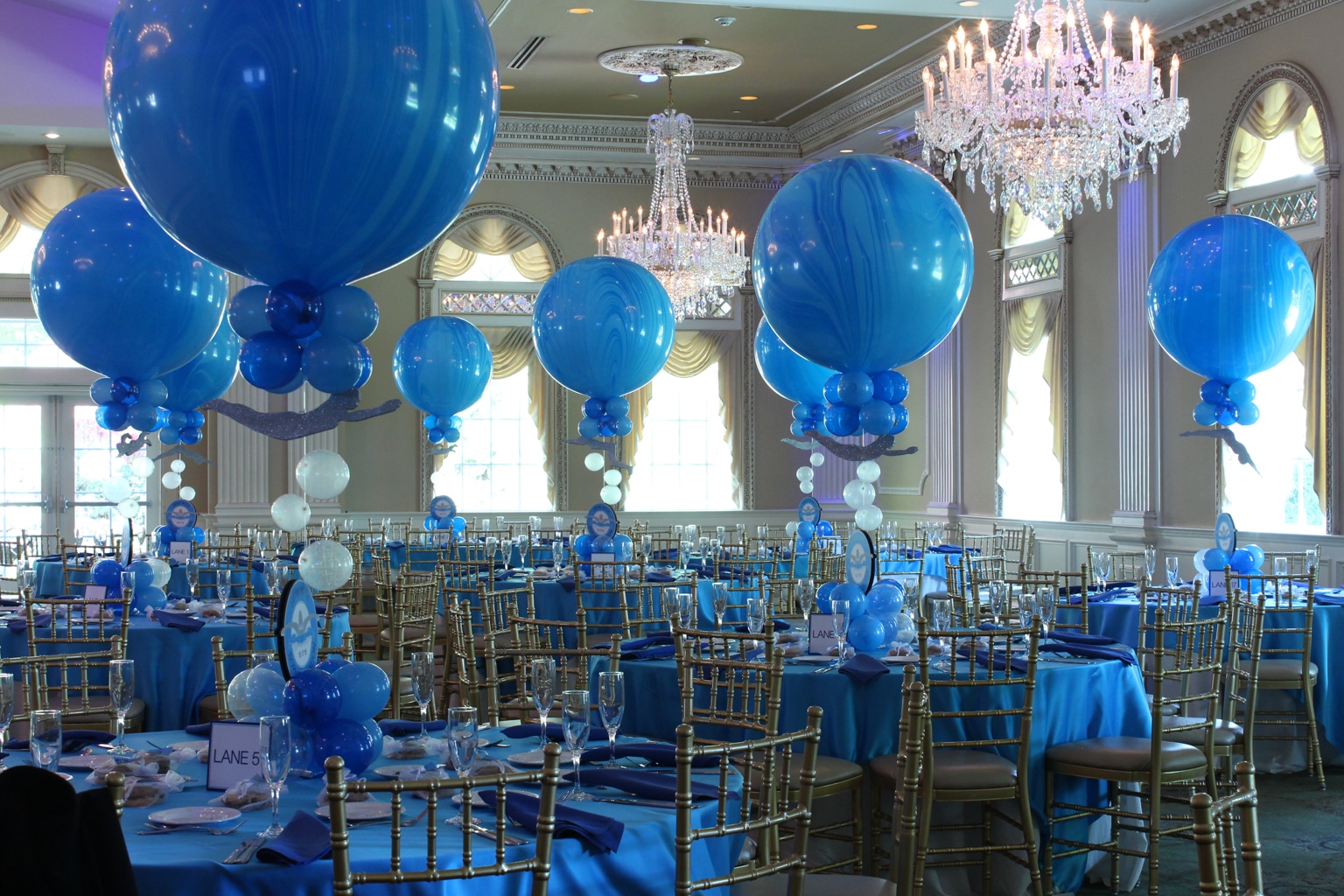 Blue Marble Balloon Centerpiece with Logo Cutout and Floating Swimmers
