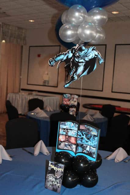 Comic Book Themed Centerpiece with Floating Superheroes and Table Signs