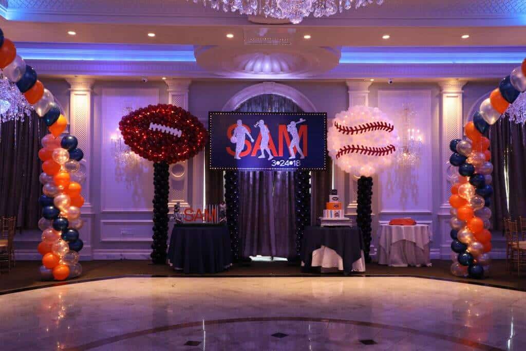 Football and Baseball Balloon Sculptures on Either Side of Custom Logo Backdrop for ESPN Themed Bar Mitzvah at The Rockleigh