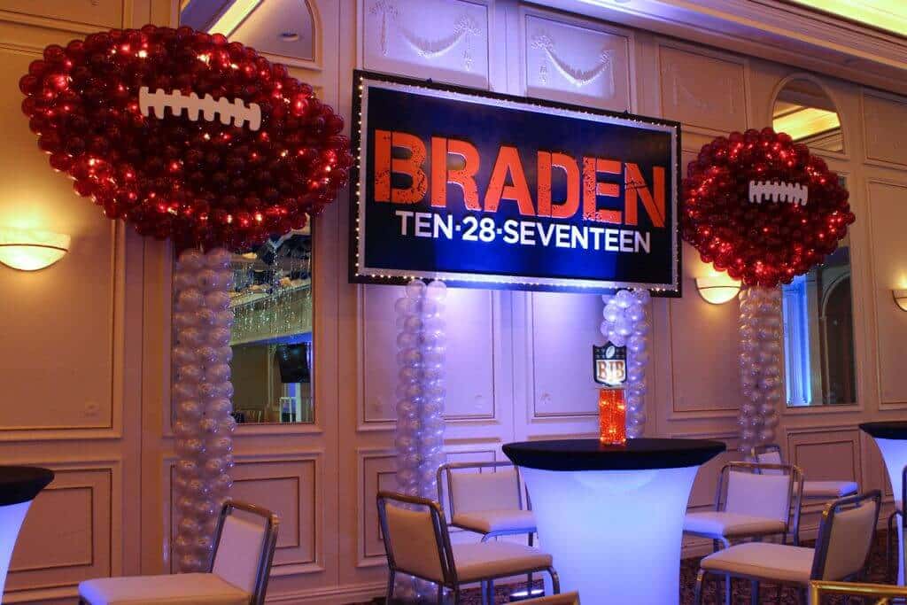 Football Balloon Sculptures near Custom Backdrop for NFL Themed Bar Mitzvah