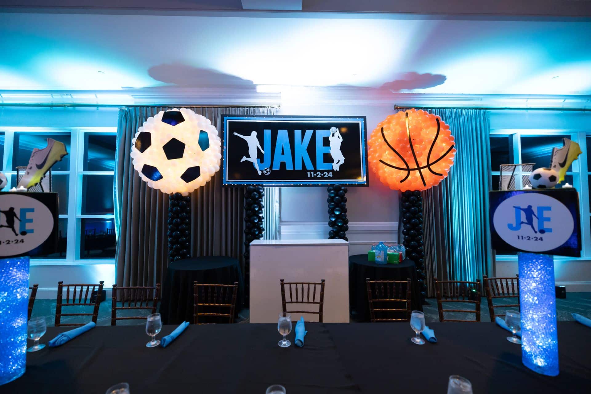 Soccer Ball and Basketball Balloon Sculptures Next To a Hand Cut Backdrop on a Balloon Stand for a Bar Mitzvah