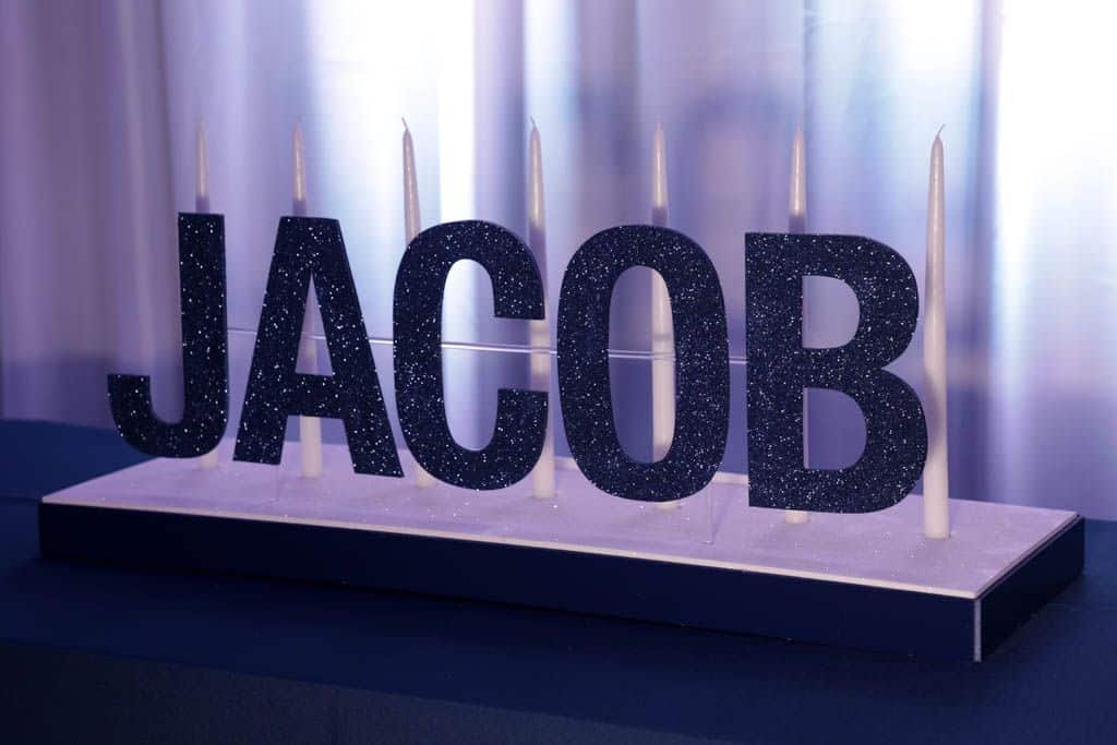 Simple Bar Mitzvah Candle Lighting Display with Navy Glittered Name and White Pillar Candles