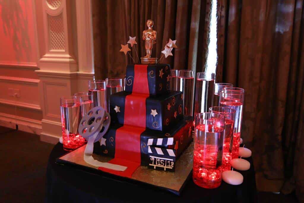 LED Cylinders with Floating Candles around Cake for Movie Themed Bat Mitzvah