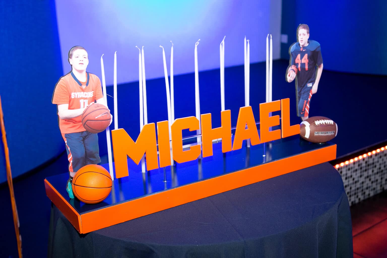 Syracuse Themed Candle Lighting Display with Photo Cutouts and Sports Balls