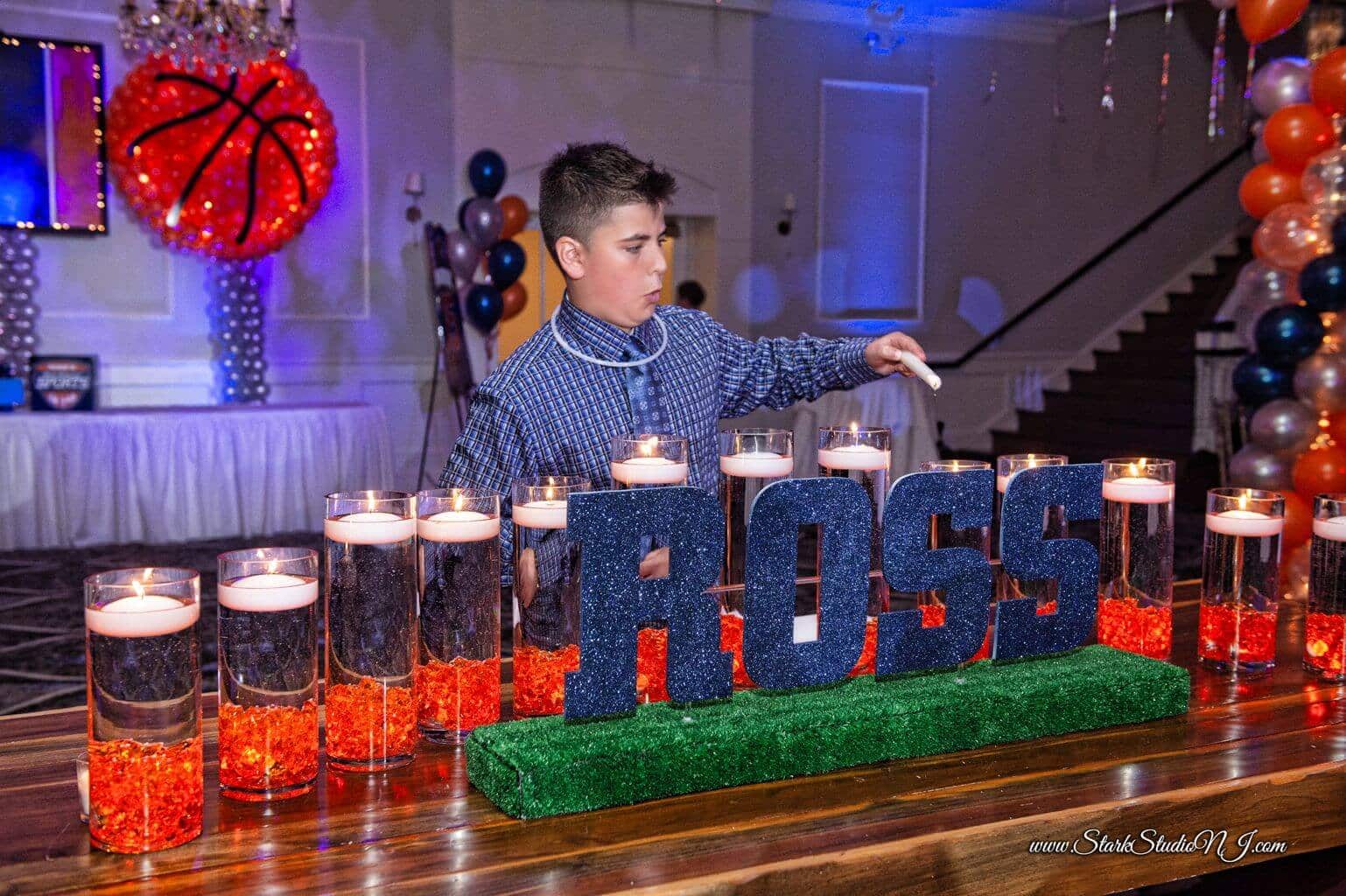 LED Candle Lighting Display with Navy Glittered Name and Orange Cylinders