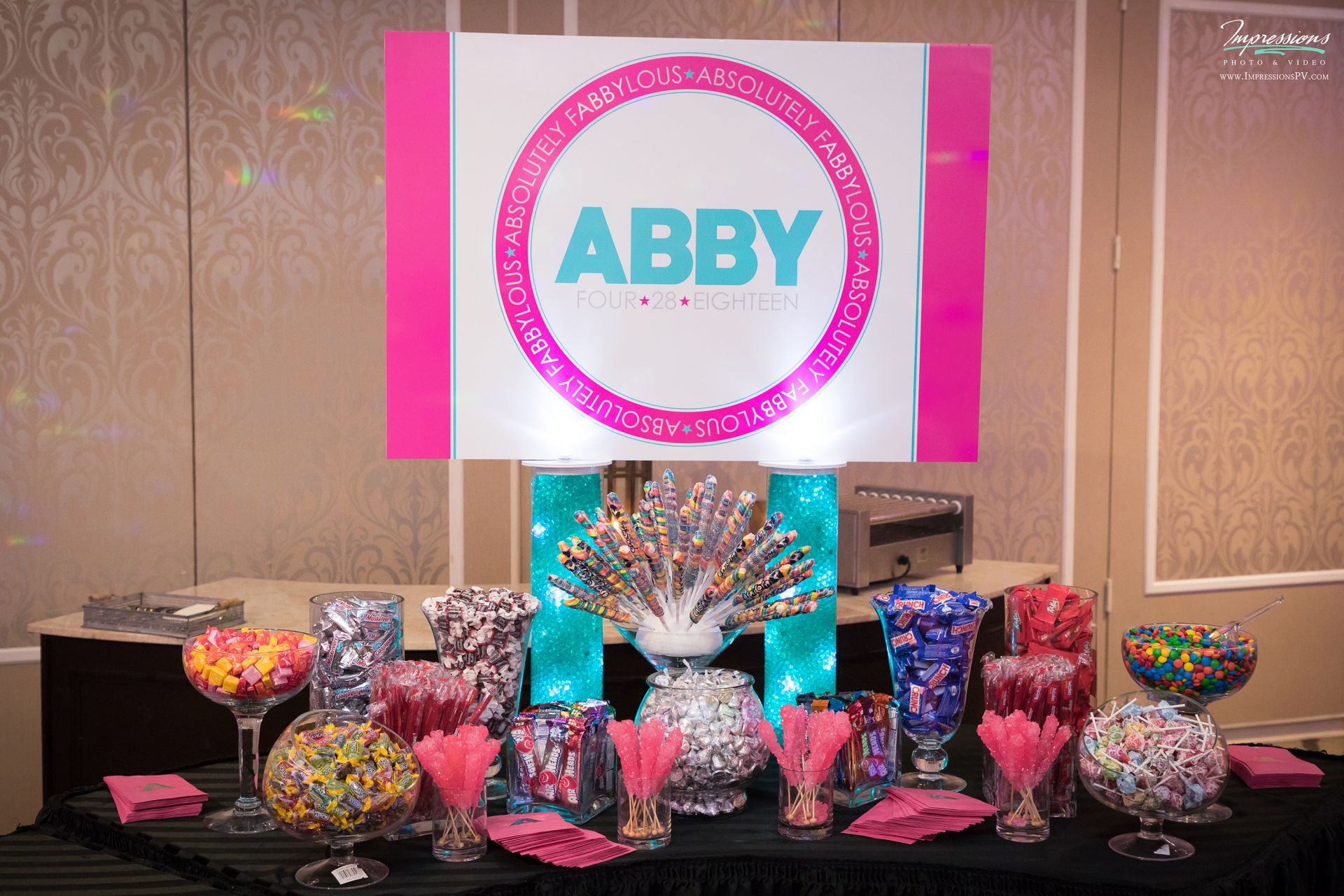 Pink and Turquoise Candy Bar Set Up with Assortment of Candies and Custom Logo Sign for Bat Mitzvah