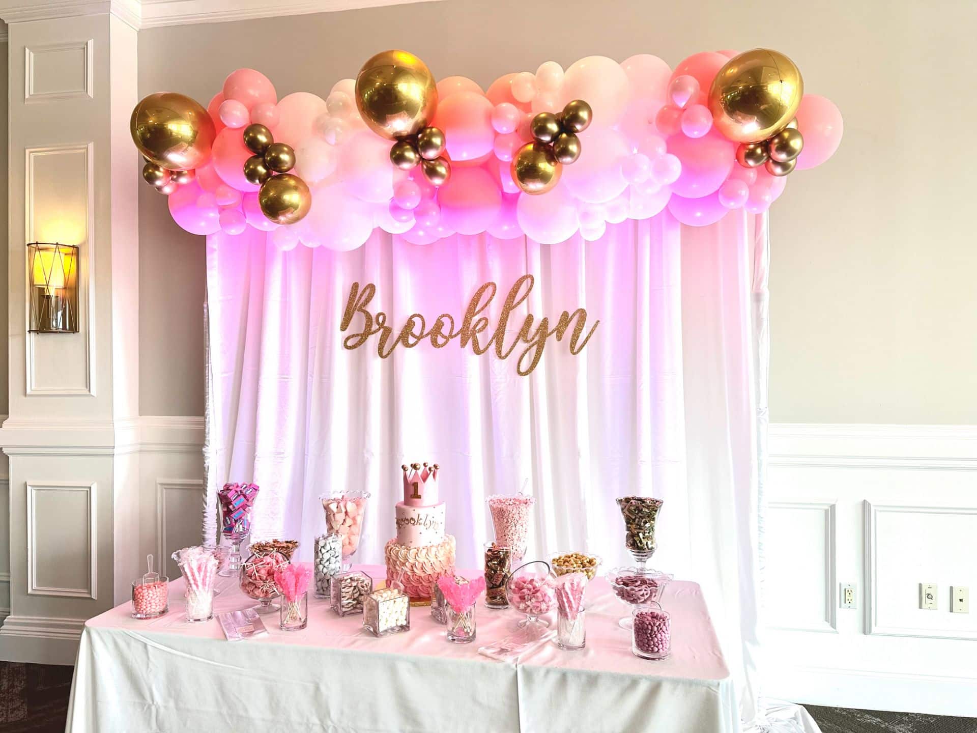 Birthday Party Candy Bar with Balloon Garland and Custom Glitter Name on Draping