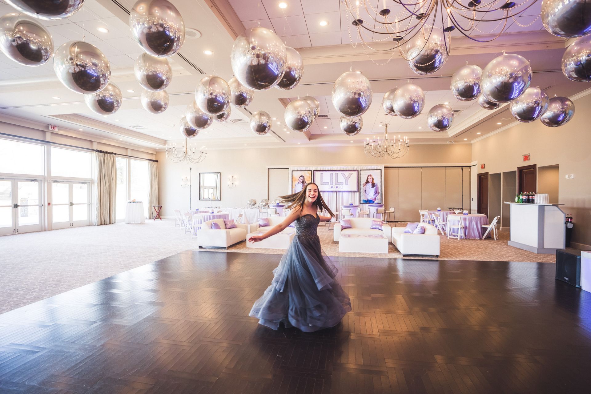 Beautiful Metallic Silver Orbz Ceiling Treatment for Bat Mitzvah Decor with Custom Backdrop and Blow Up Pictures, Custom Cube Cocktail Centerpiece and Custom Lounge Set Up with Pillows