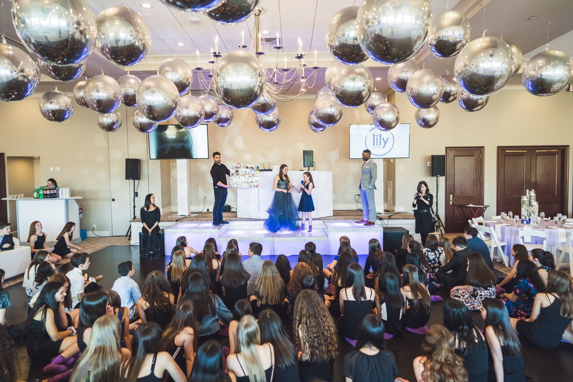 Metallic Silver Orbz Ceiling Treatment Over Dance Floor and LED Orchids Centerpiece for Bat Mitzvah Decor