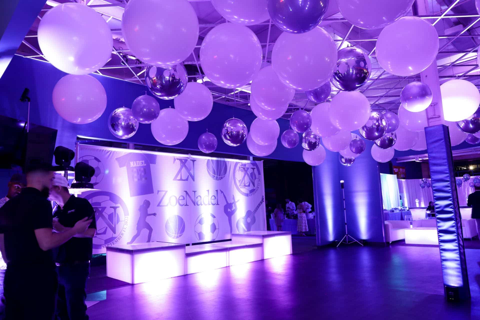 White and Silver Ceiling Balloon Treatment with Custom Logo Mural for Bat Mitzvah at Urban Air