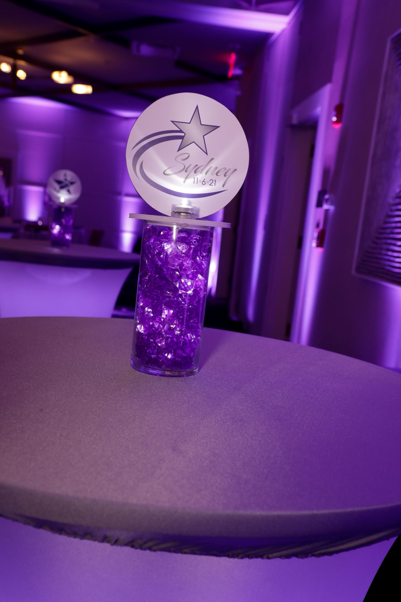 Beautiful Star Themed LED Custom Mini Logo Topper Centerpiece Over Purple Chips for Bat Mitzvah Lounge Set Up