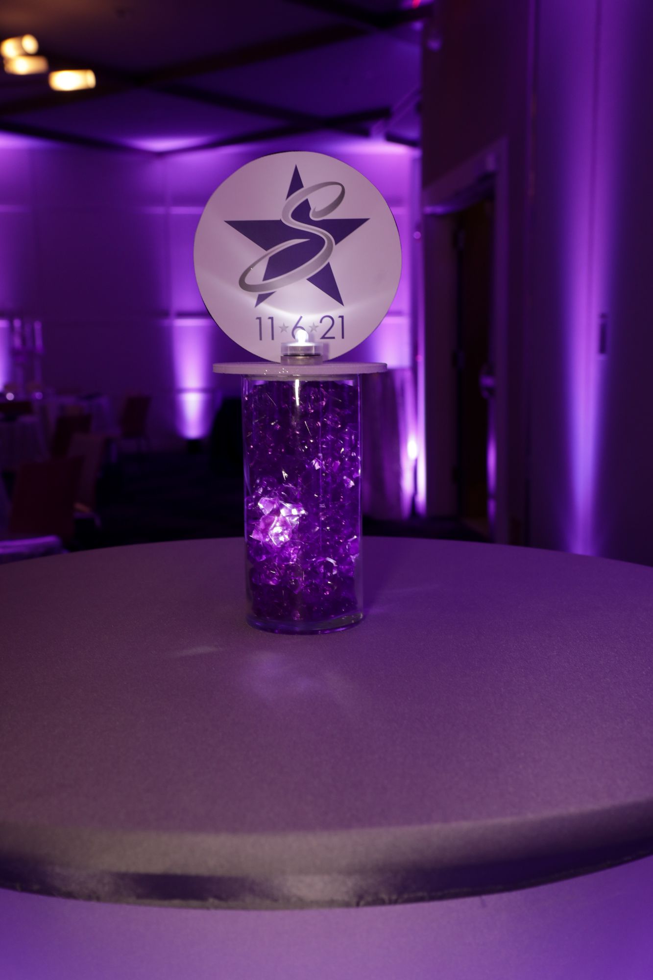 Beautiful Star Themed LED Custom Mini Logo Topper Centerpiece Over Purple Chips for Bat Mitzvah Lounge Set Up