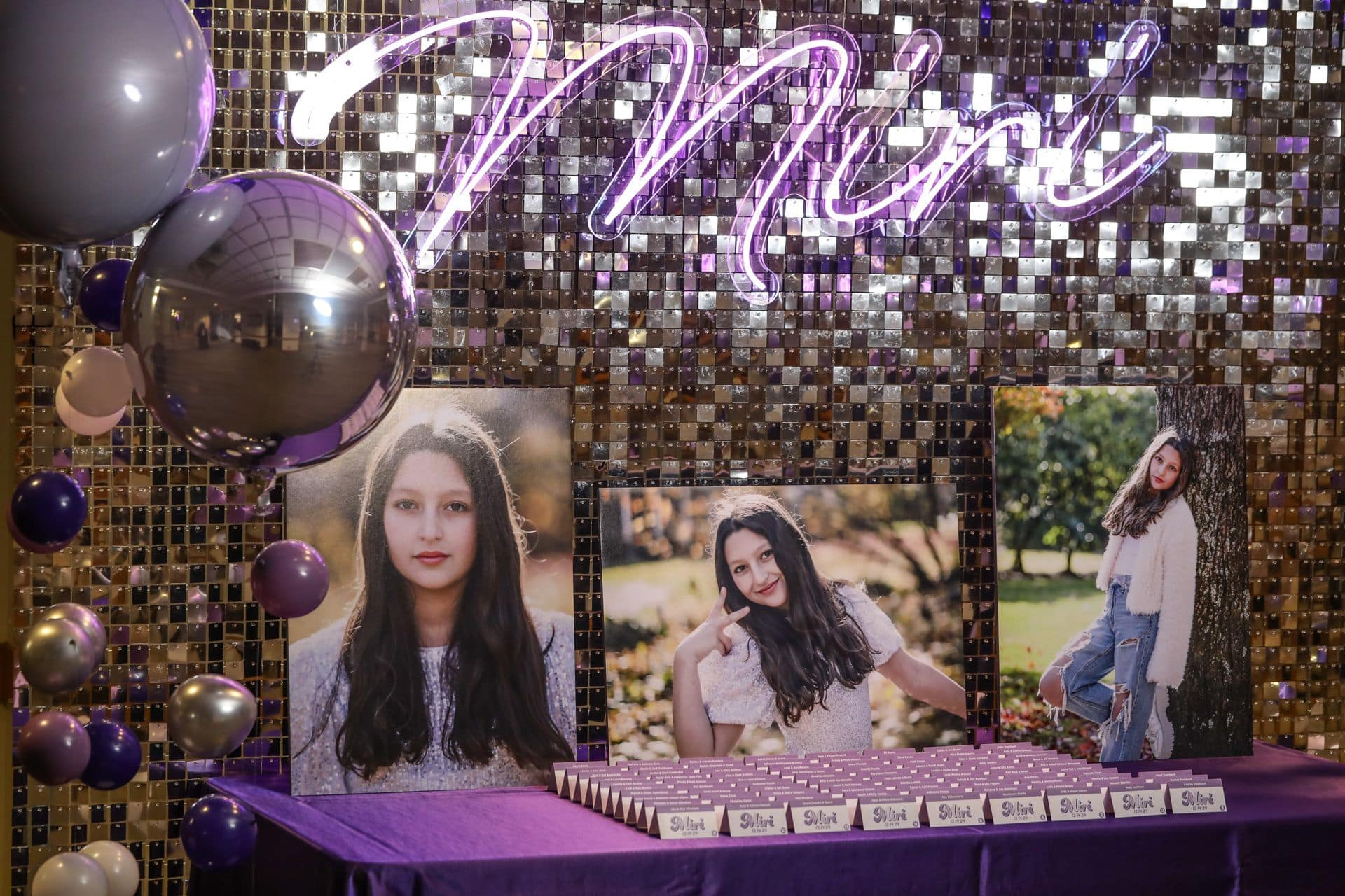 Blow Up Photos with Place Cards and an LED Sign on a Silver Disco Backdrop for a Bat Mitzvah Entrance Display