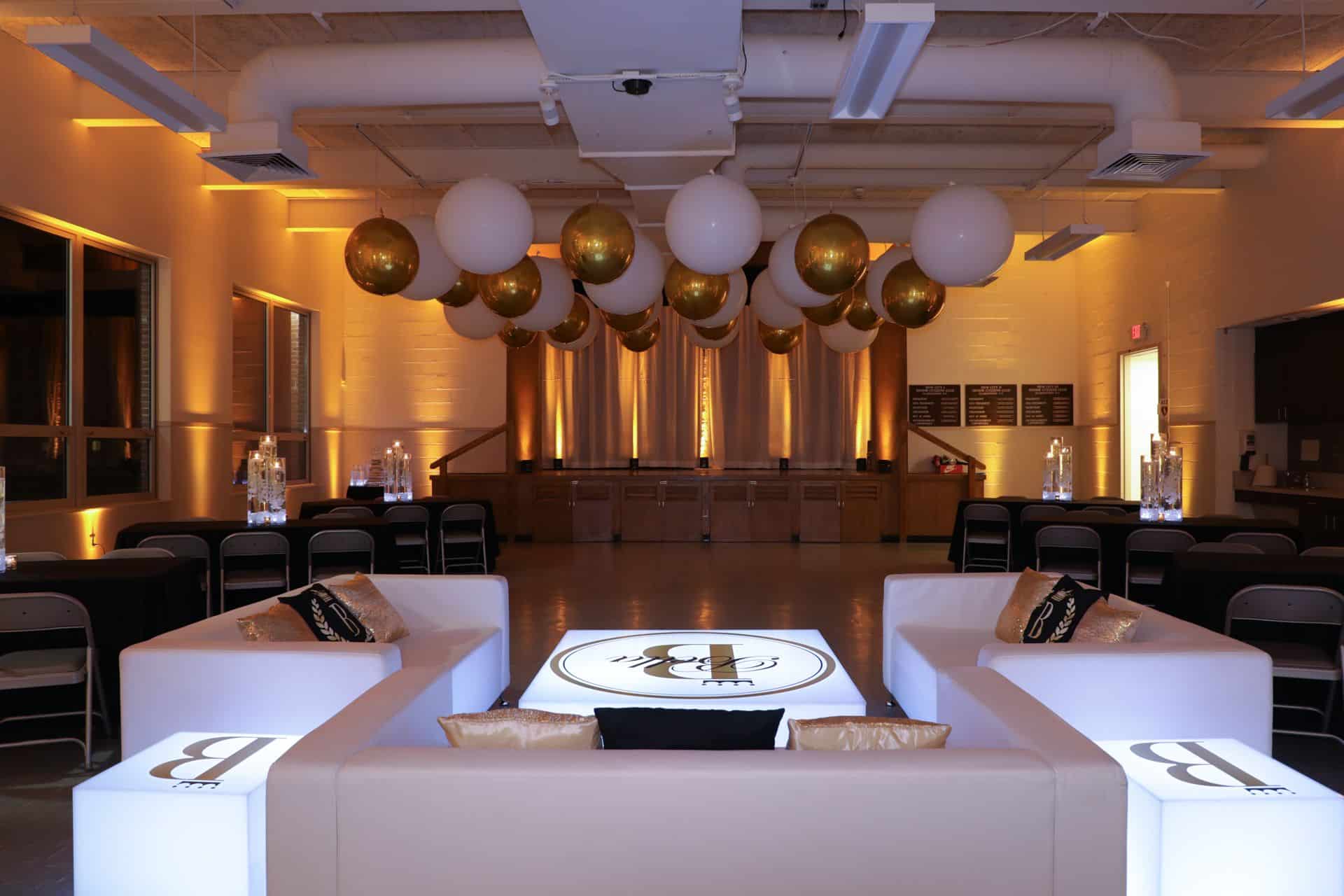 Sweet Sixteen Lounge with Custom Furniture, White and Gold Ceiling Balloons and Amber Uplighting
