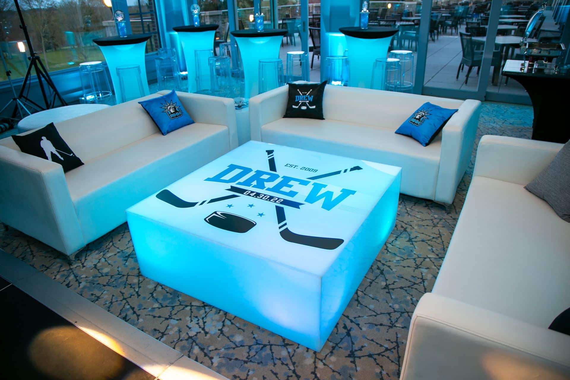 Hockey Themed Lounge with LED Logo Tables and Custom Pillows at Fairview Country Club