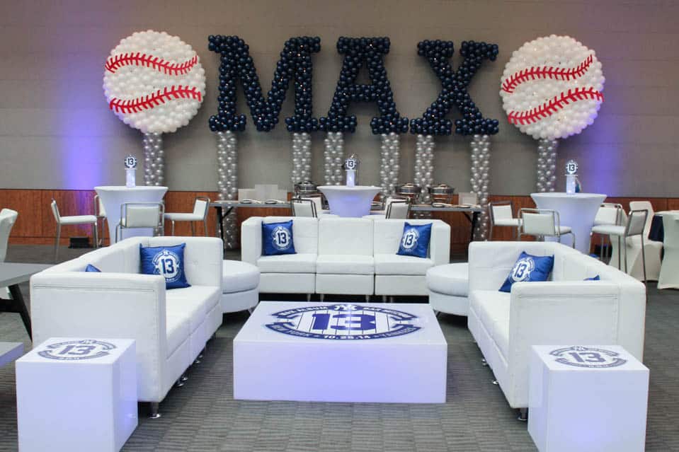 Yankees Themed Lounge with Custom Pillows, Logo Decals and Name in Balloons with Baseball Sculptures