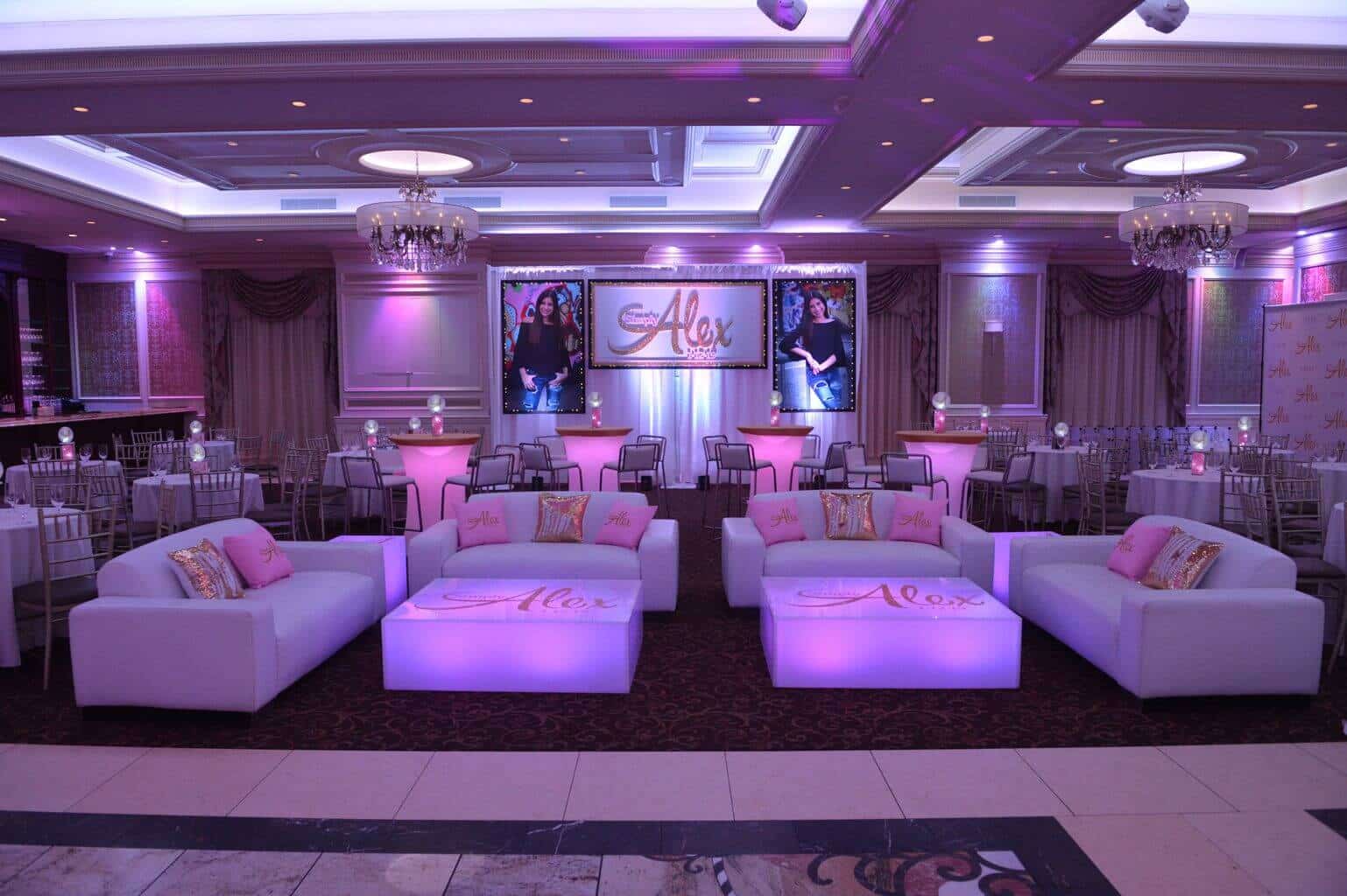 Light Pink and Gold Bat Mitzvah Lounge with LED Furniture, Custom Pillows and Logo In Front of Photo Backdrop at The Terrace at Biaggios