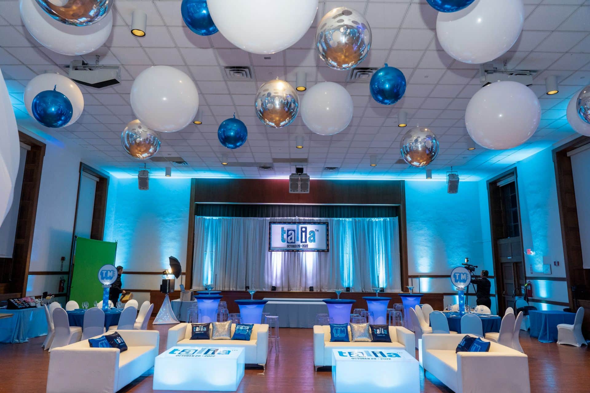 Blue LED Lounge Setup with Custom Logo Tables, Pillows and Backdrop on Pipe and Drape at TIC, White Plains