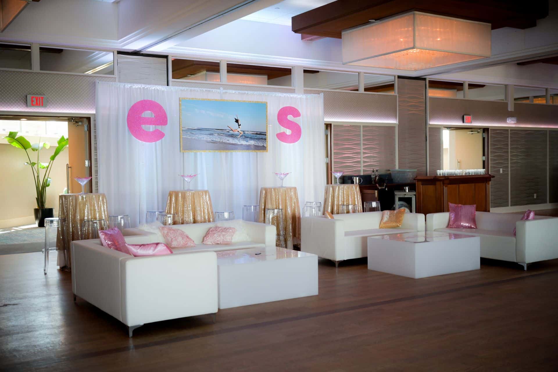 Custom Led Lounge with Custom Pillows in front of Pipe and Drape with Hand Cut Sign and Glitter initials at Crescent Beach Club