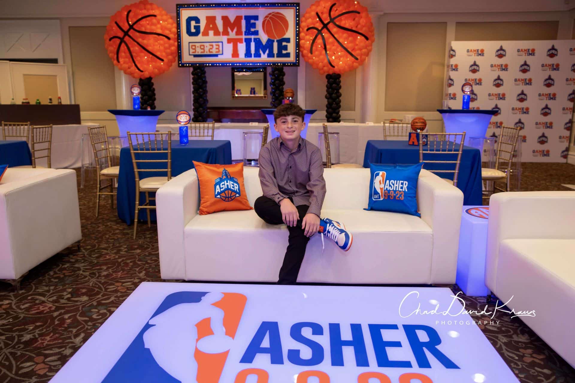 Basketball Themed Bar Mitzvah Lounge with Custom Logo Tables and Pillows at Hampshire Country Club