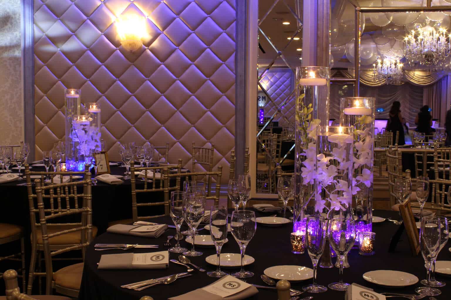 LED Orchid Centerpiece with Blue and Purple Crystal Chips and Floating Candles at Seasons Catering