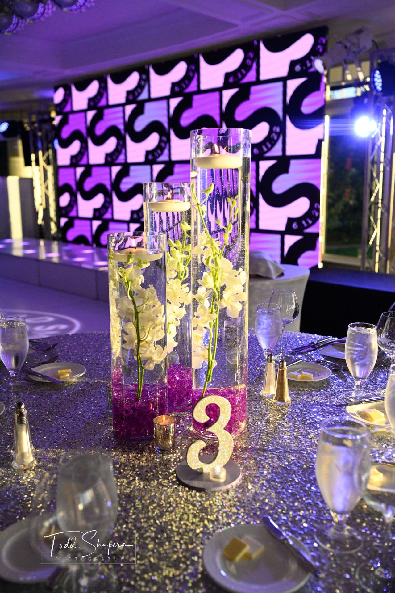 Orchid Centerpiece with Purple Chips and Floating Candles