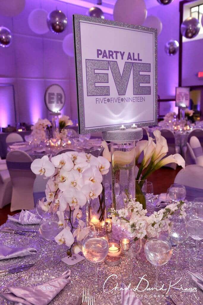 Custom LED Logo Centerpiece with Glittered Border and Floral Accents from Monica Chimes Floral