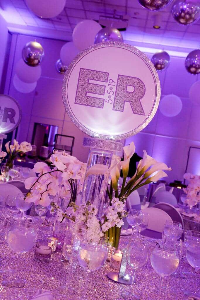 Custom LED Logo Centerpiece with Glittered Border and Floral Accents from Monica Chimes Floral