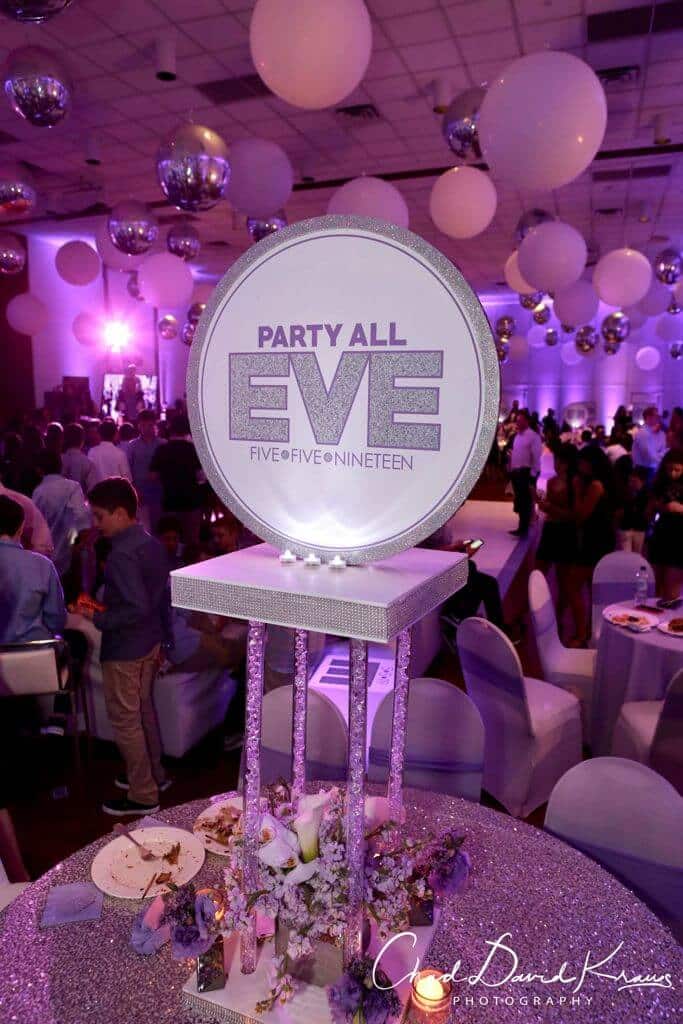 Custom LED Logo Centerpiece with Glittered Border and Floral Accents from Monica Chimes Floral