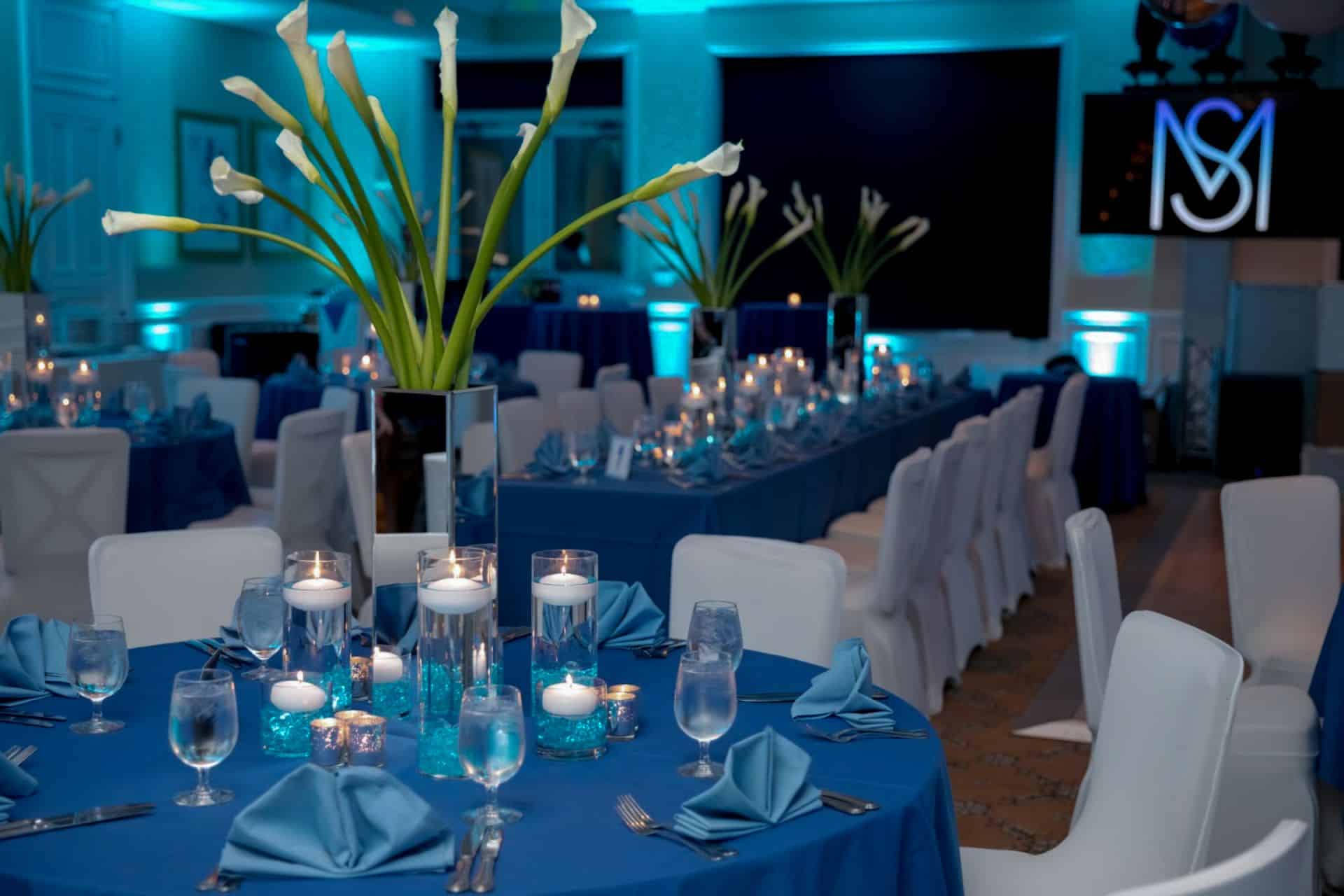Floral Calla Lily Centerpiece with Turquoise LED Cylinders and Floating Candles at Tamarack Country Club
