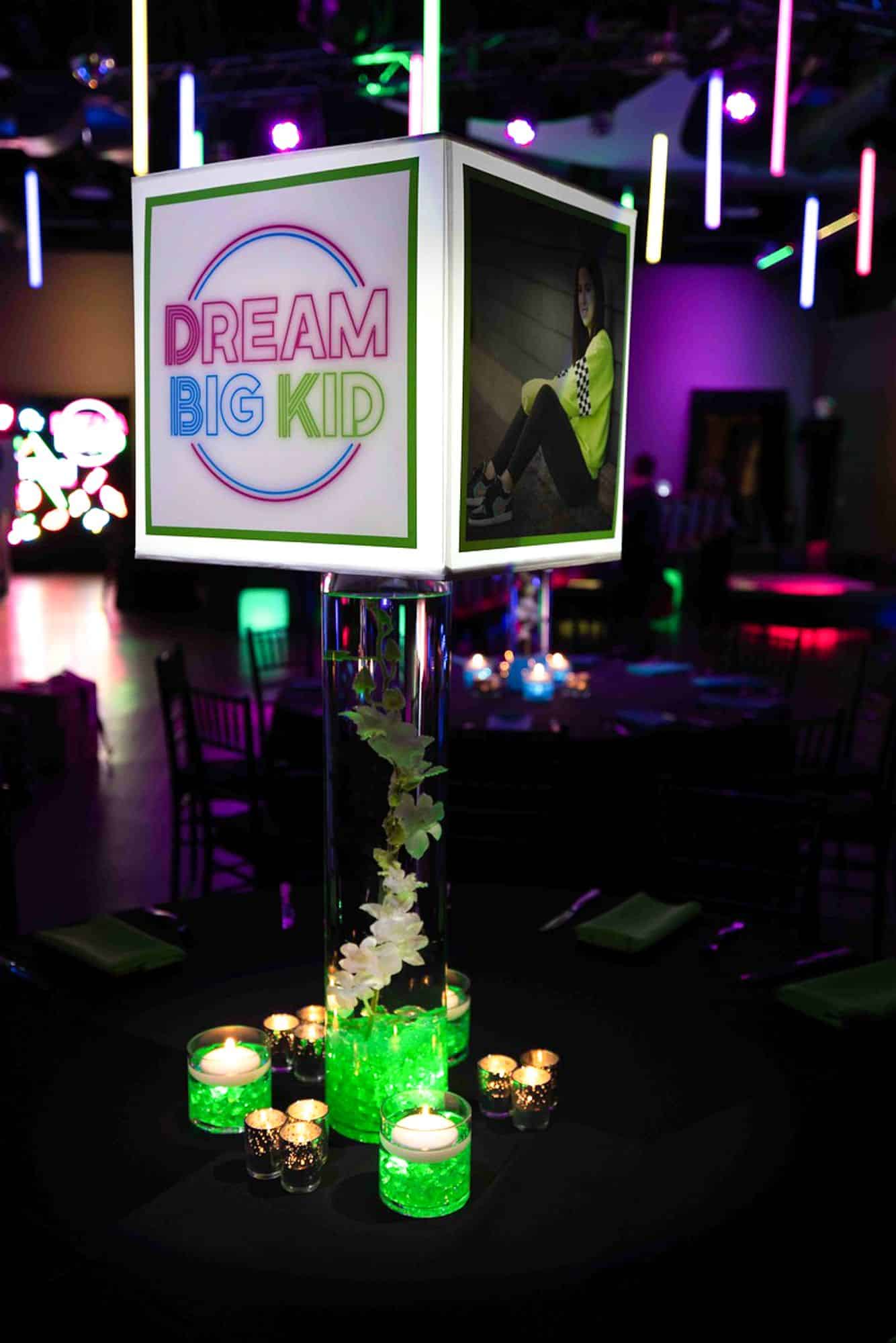 Neon Lampshade Centerpiece on LED Cylinder with Orchids and Lime Green Chips