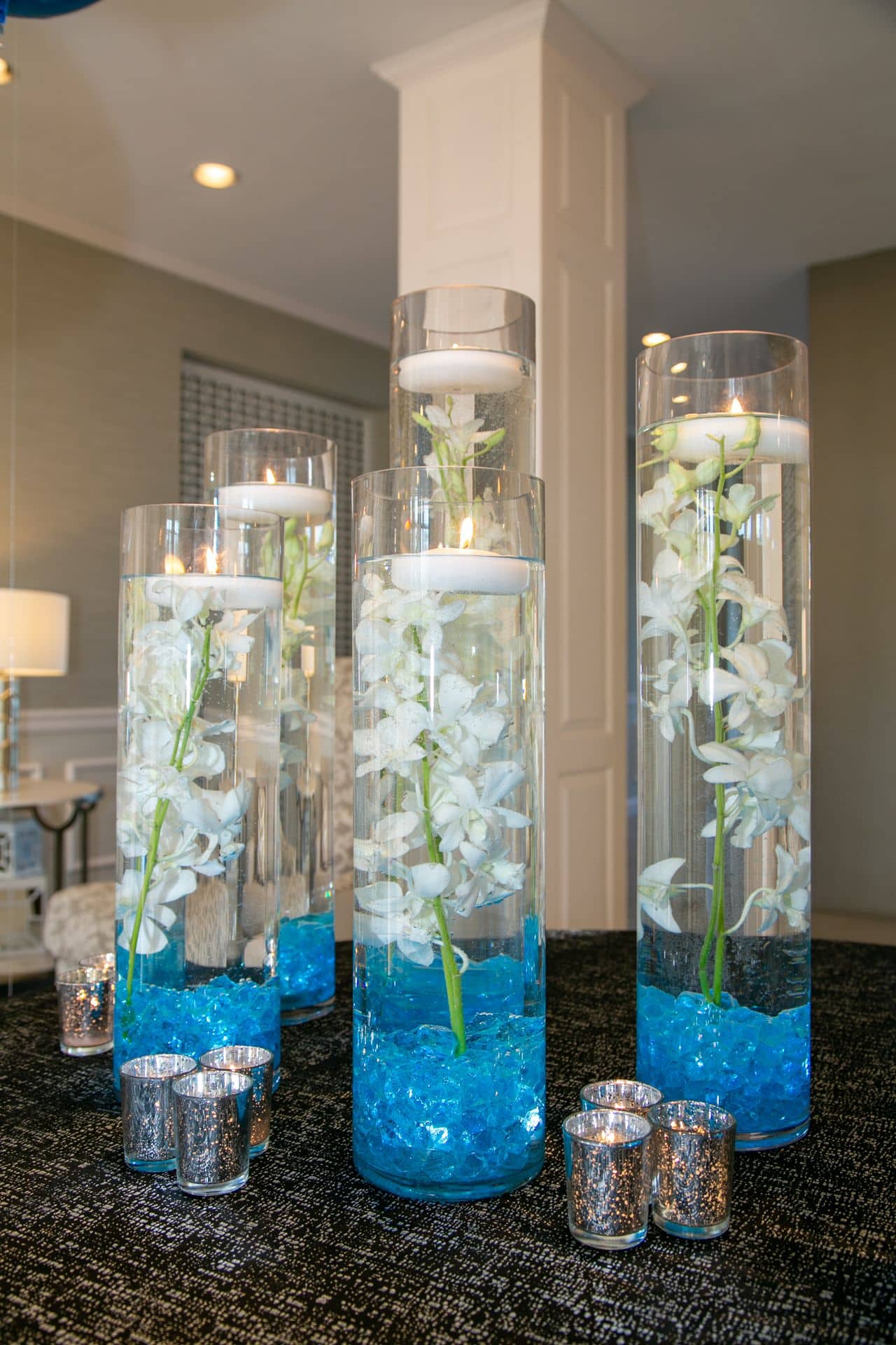 Pale Blue Orchid Centerpiece with Floating Candles and Custom Table Numbers