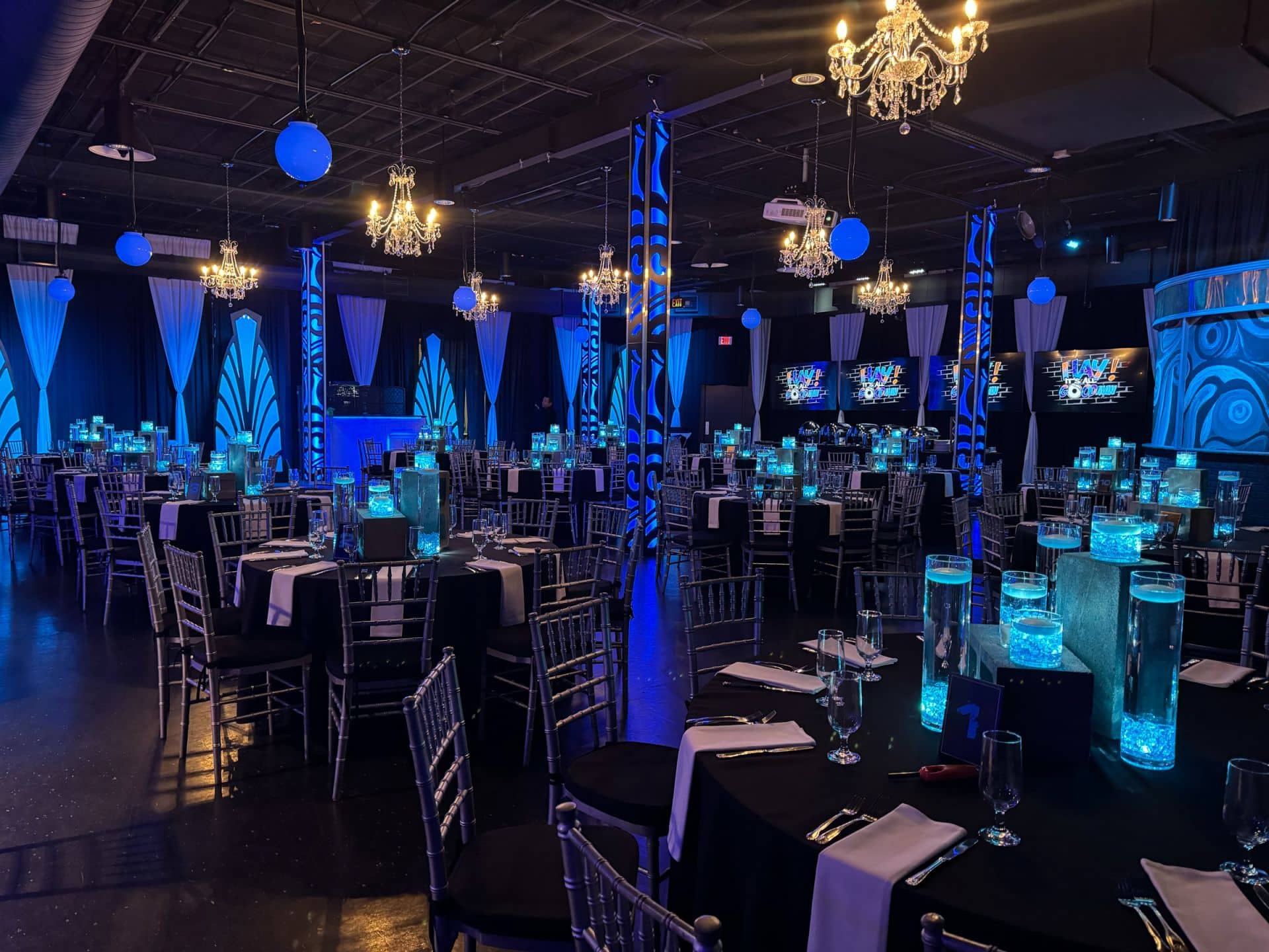 A Cinder Block Centerpiece Topped with Glass Cylinders Containing Blue LED Chips, Each Topped with a Floating Candle