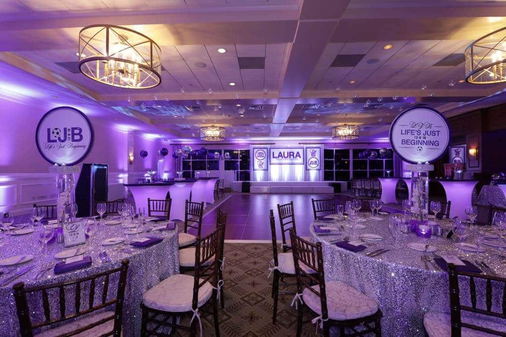 Purple Themed Bat Mitzvah with LED Orchid and Logo Centerpieces, Custom Backdrop and Purple Uplighting at Paramount Country Club, NY