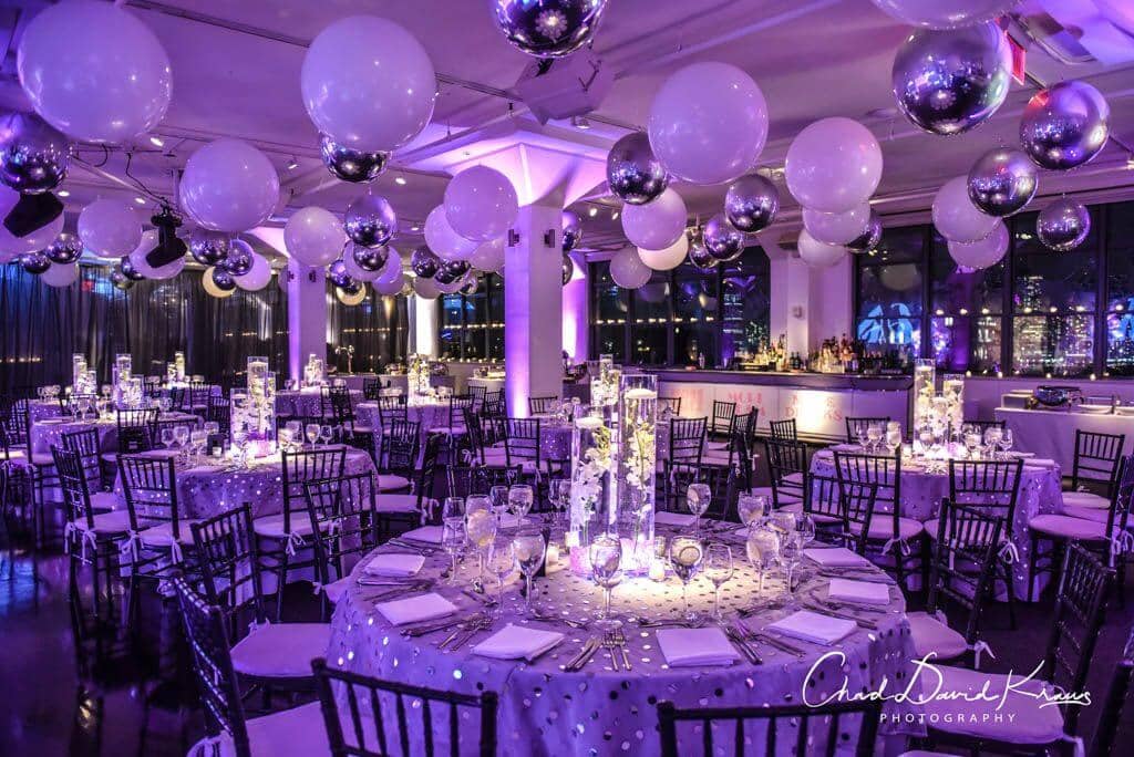 Beautiful Bat Mitzvah Setup with White and Silver Ceiling Balloons and LED Orchid Centerpieces at Tribeca 360, NYC