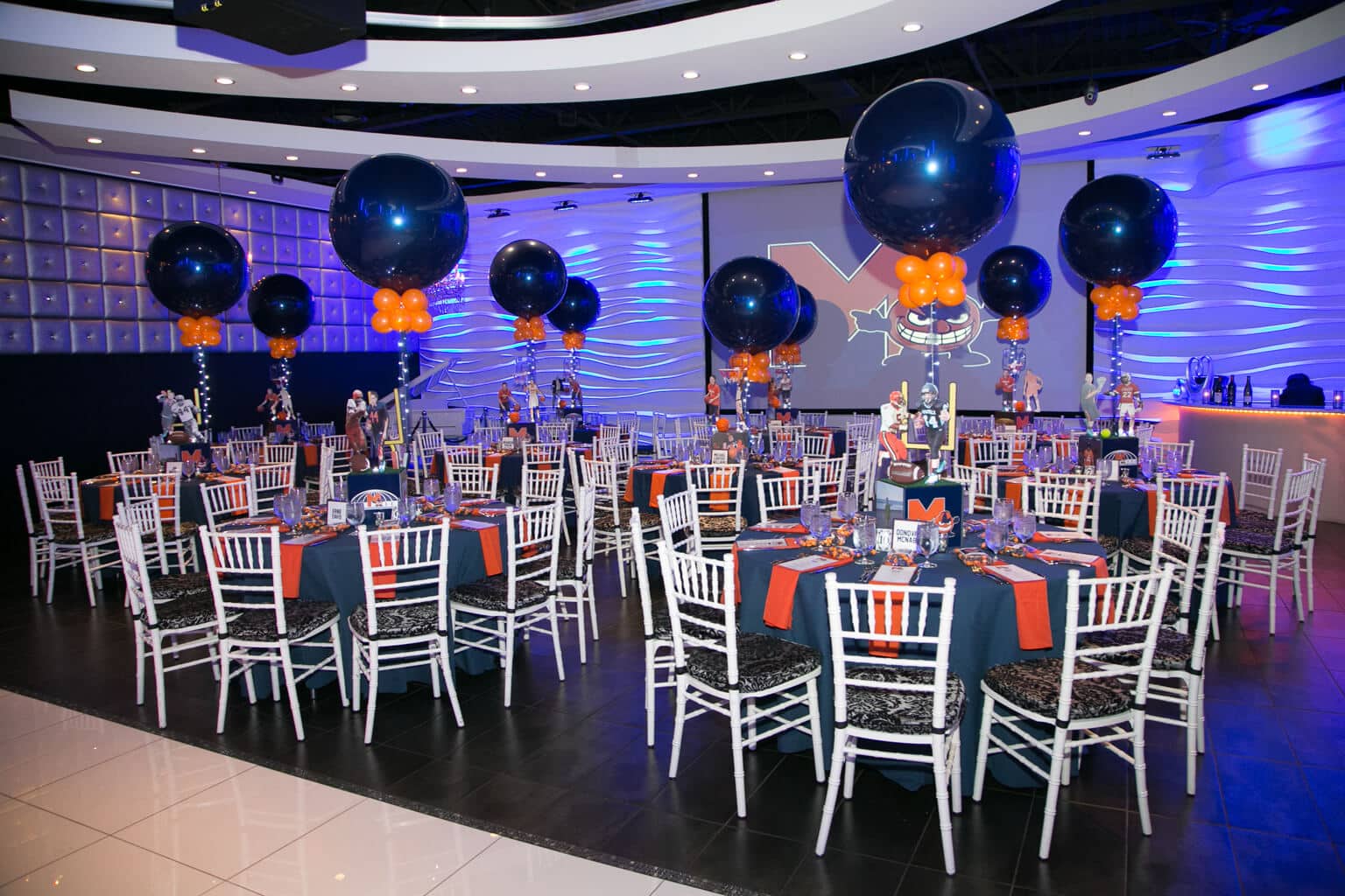 Syracuse Themed Bar Mitzvah with Football Centerpieces and 36" Navy and Orange Balloons at Club Vegas