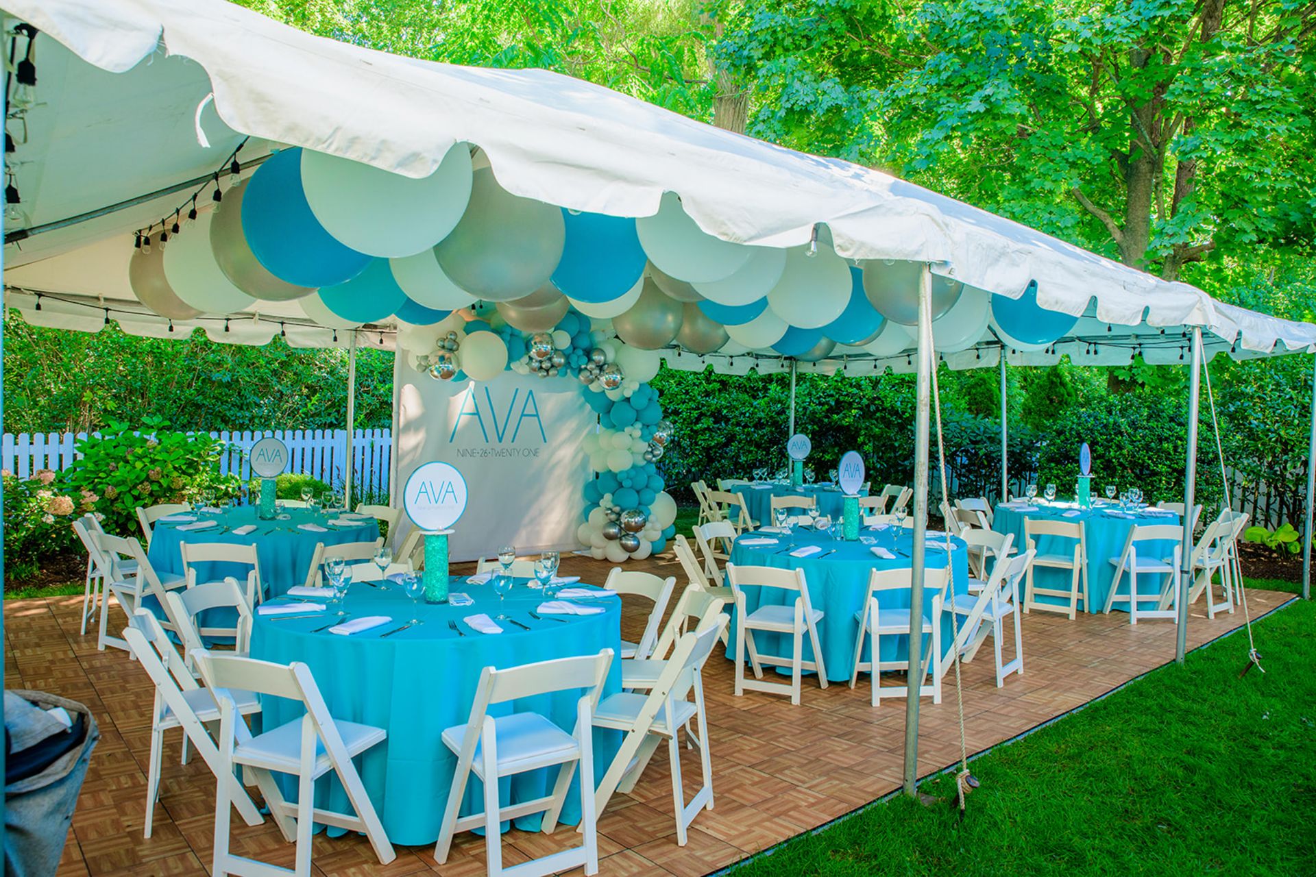 Beautiful Bat Mitzvah Tent Party Set Up with Large Balloons Ceiling Treatment, Organic Half Arch Around Custom Step and Repeat