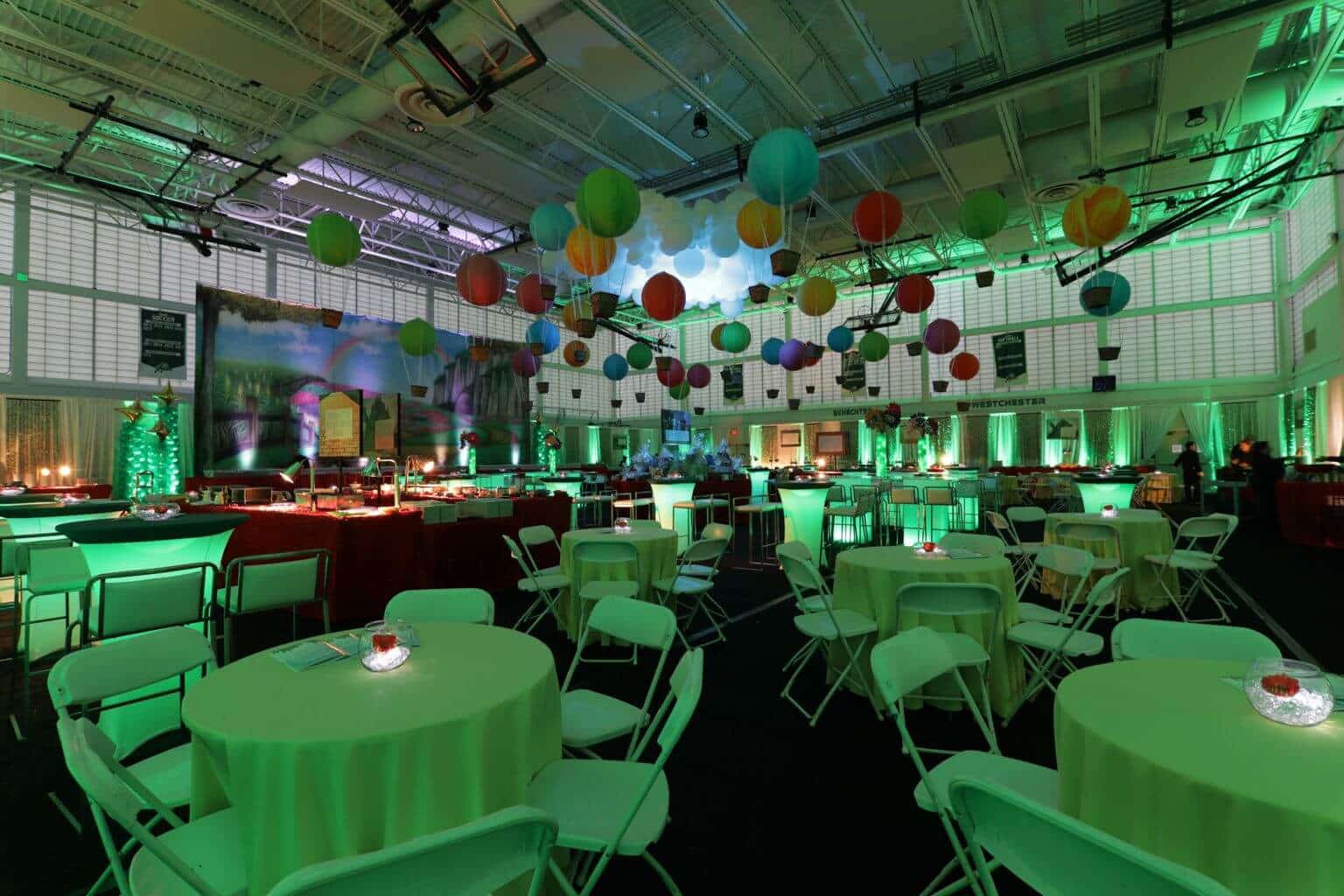 Emerald City Room Setup with Hot Air Balloons and Cloud Sculptures on Ceiling, Wall Mural and LED Lighting at Solomon Schechter Upper School