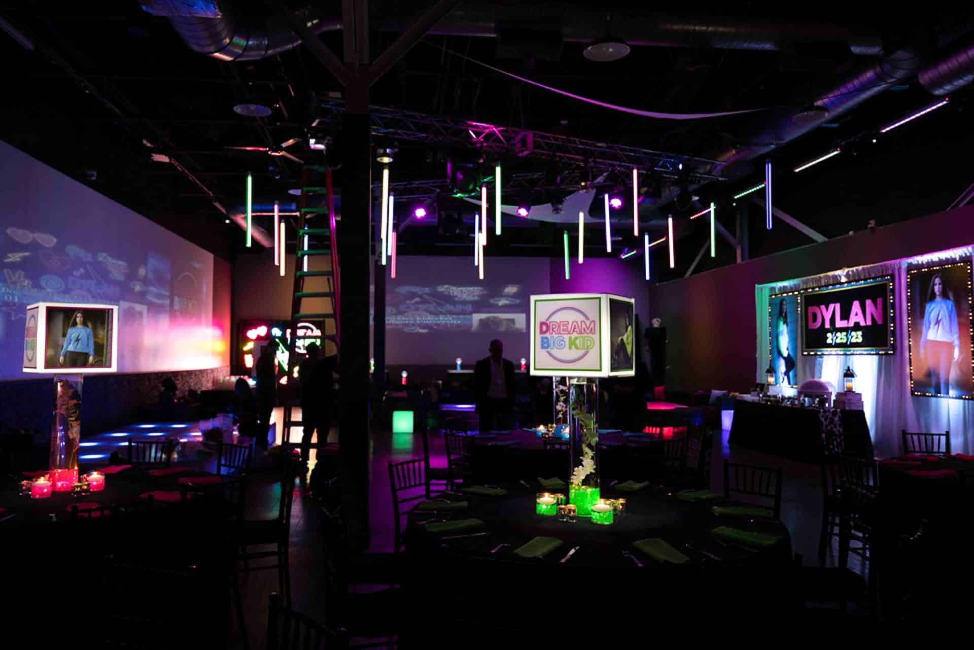 Neon Theme Bat Mitzvah Room with Lampshade Centerpieces and Blow Up Photos and Backdrop