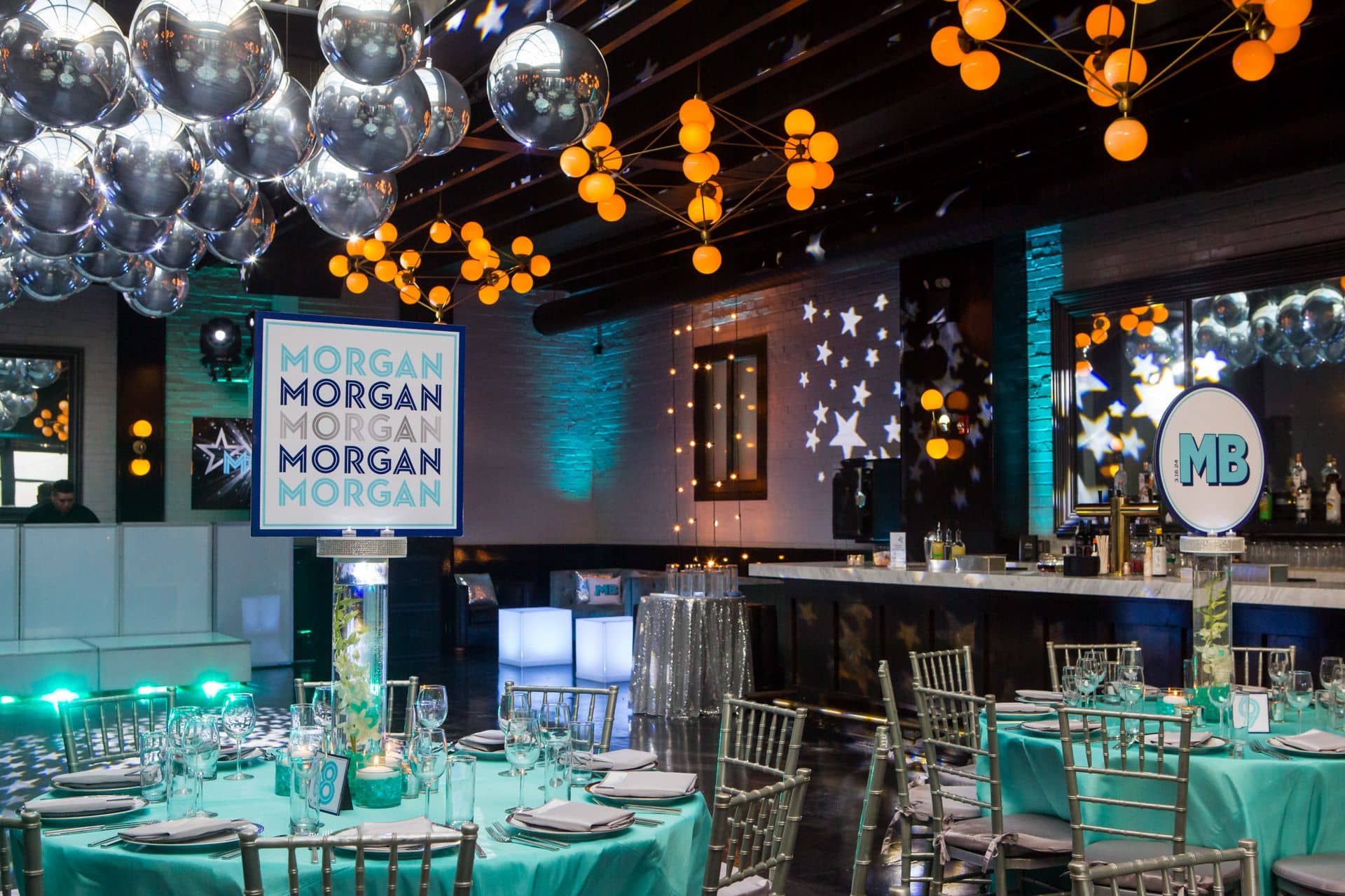 Orchid Centerpieces with Logo Toppers and a Metallic Orb Balloon Ceiling at 501 Union, Brooklyn