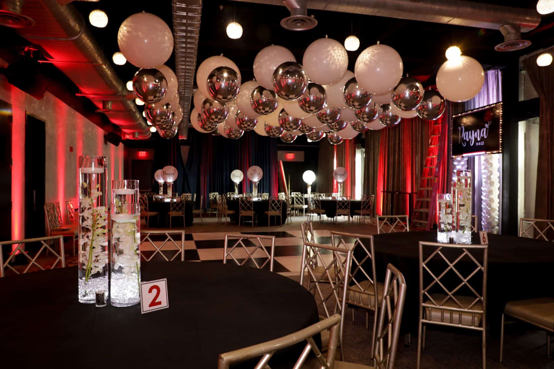 Bat Mitzvah Party Room with White and Silver Ceiling Balloons and LED Orchid Centerpieces at The Hotel Nyack