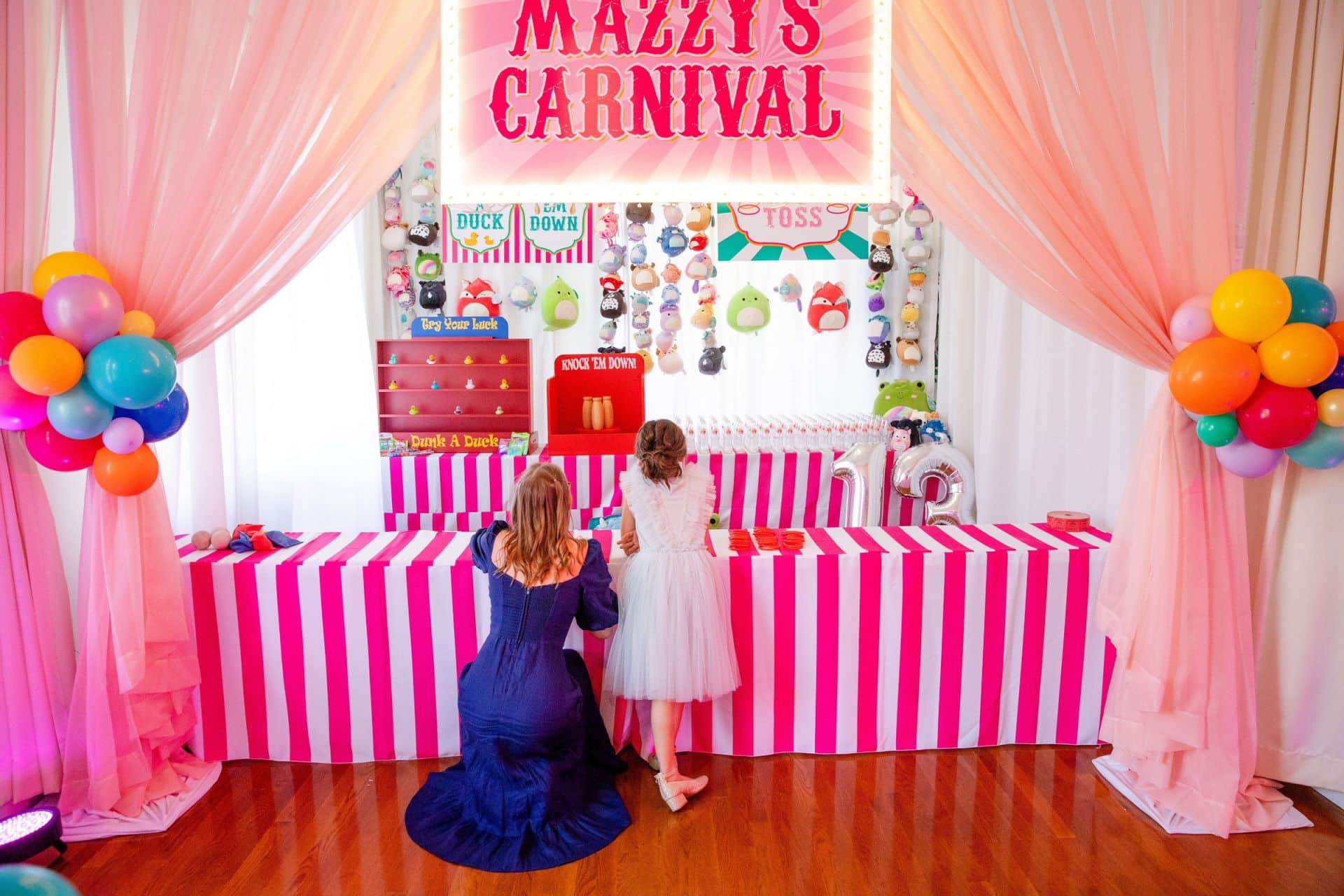 Custom Carnival Booth Setup with Draping, Custom Marquee Signage and Balloons
