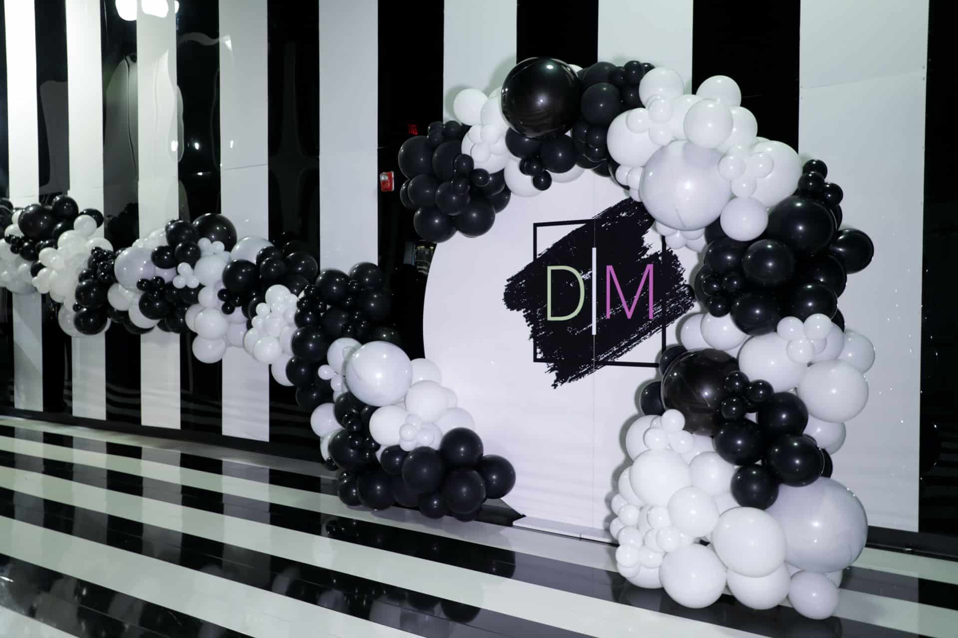 Organic Black and White Half Arch Over Custom Acrylic Wall and Organic Black and White Balloon Garland