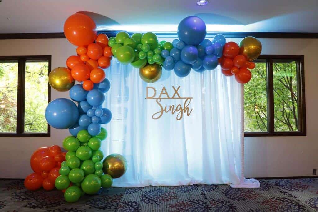 Organic Balloon Arch with Metallic Orbs and Pipe and Drape Background