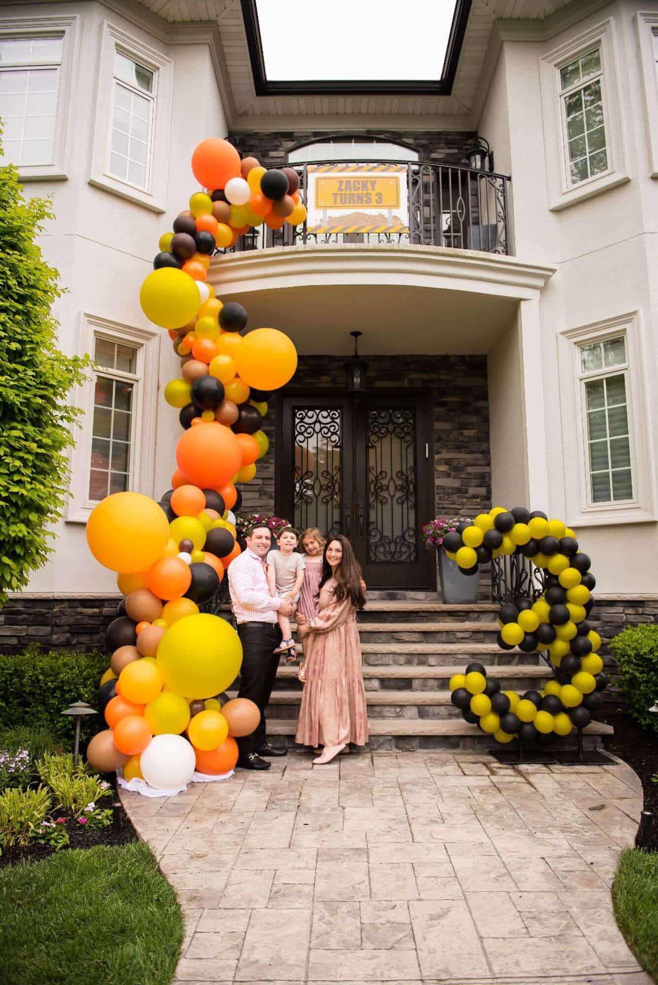 Construction Theme Organic Balloon Arch Over Entryway and Stairway for Outdoor Birthday Decor