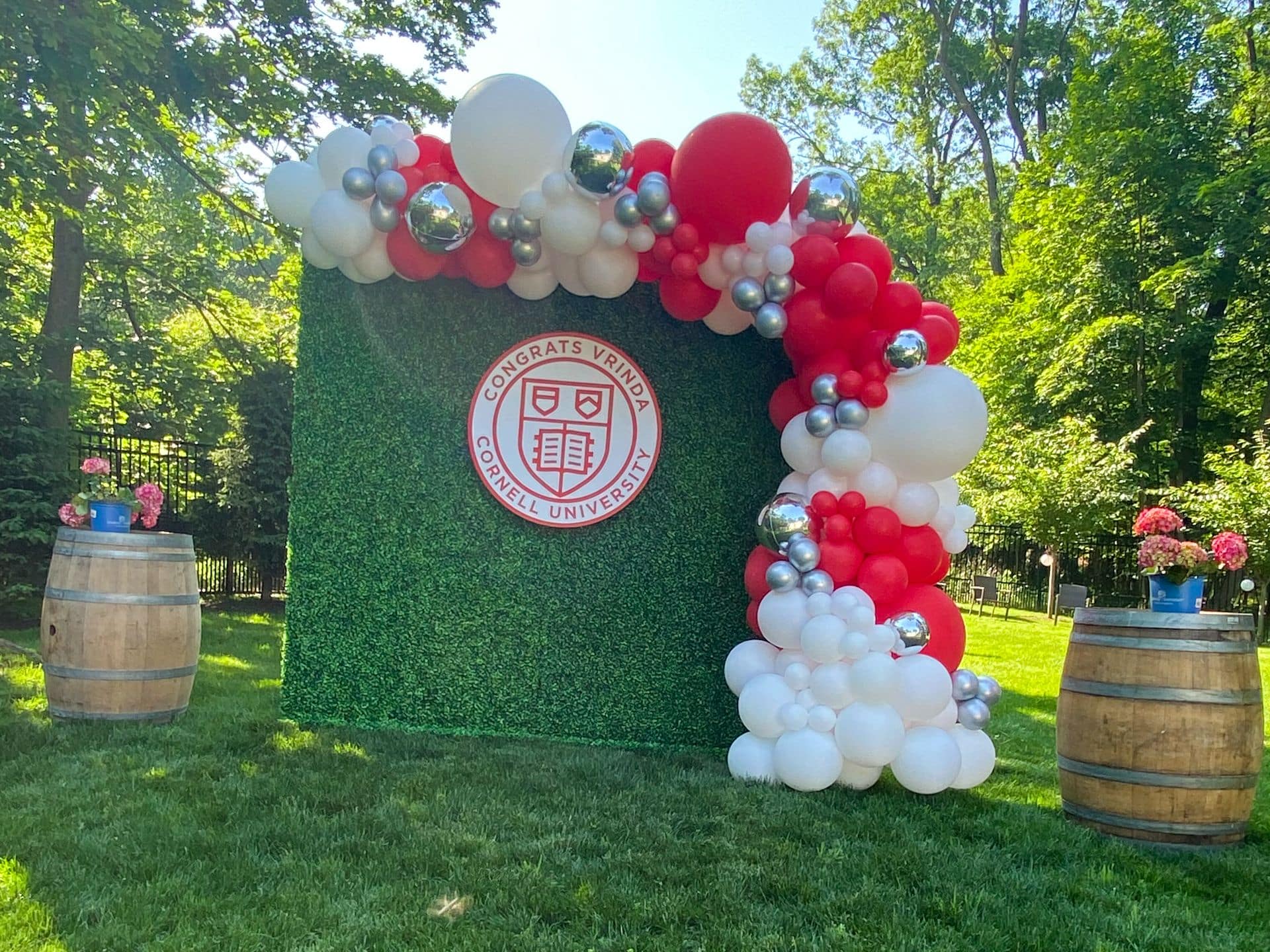 Greenery Wall with Red and White Balloon Garland and Custom sign for Graduation Party