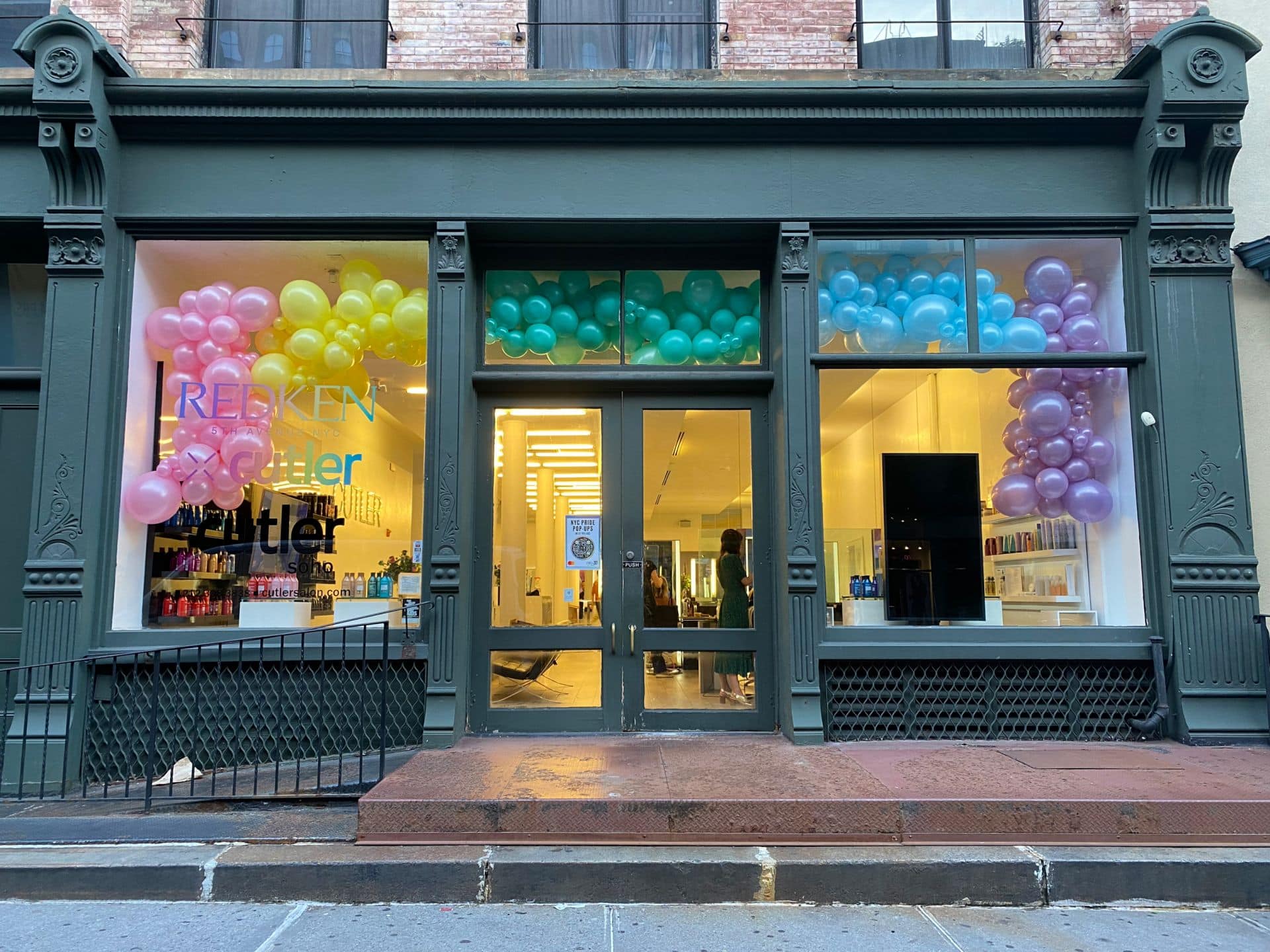 Organic Balloon Garland Around Showcase for Corporate Event Decor