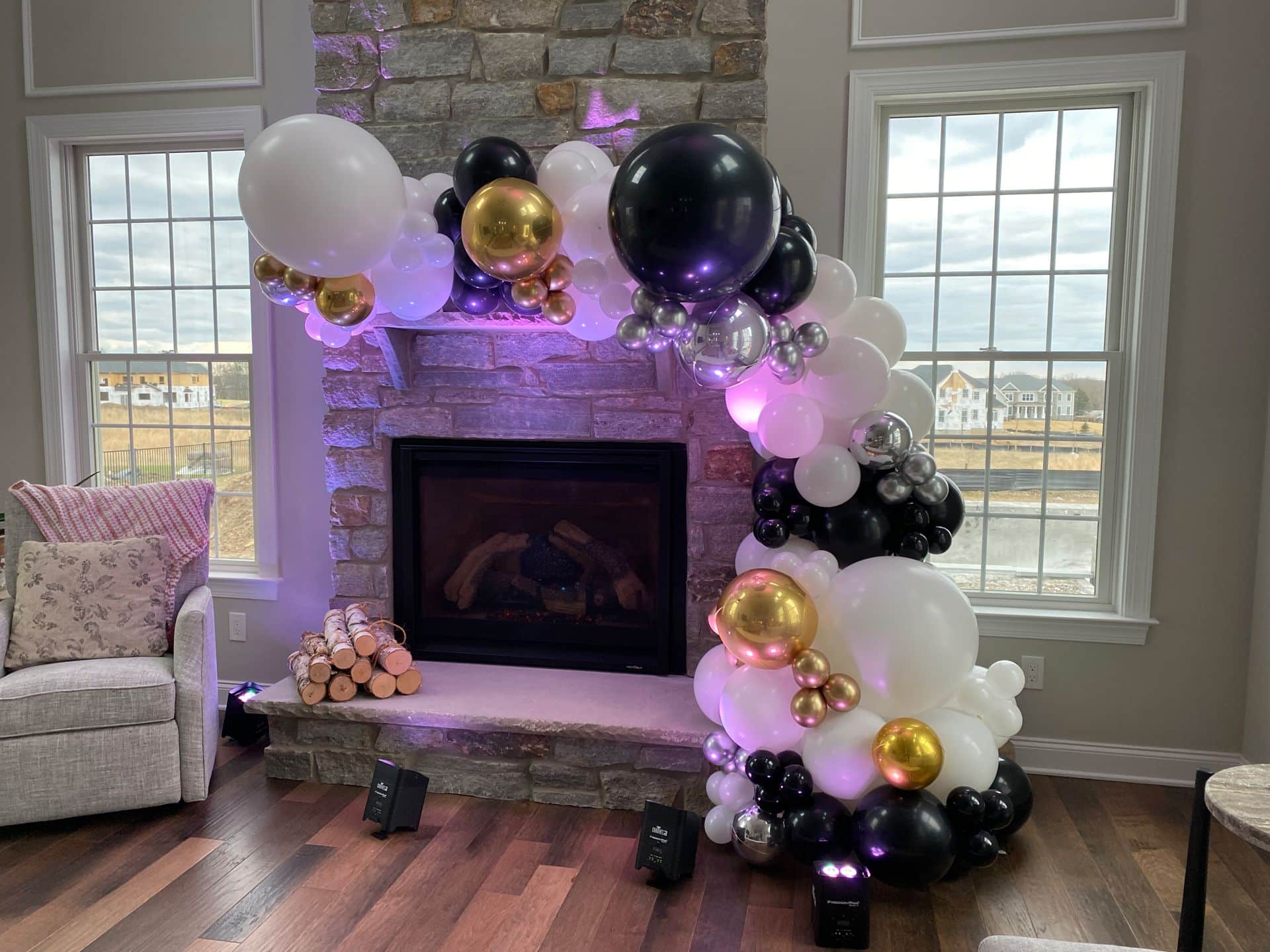 Black, White and Metallic Balloon Garland over Fireplace for Home Party
