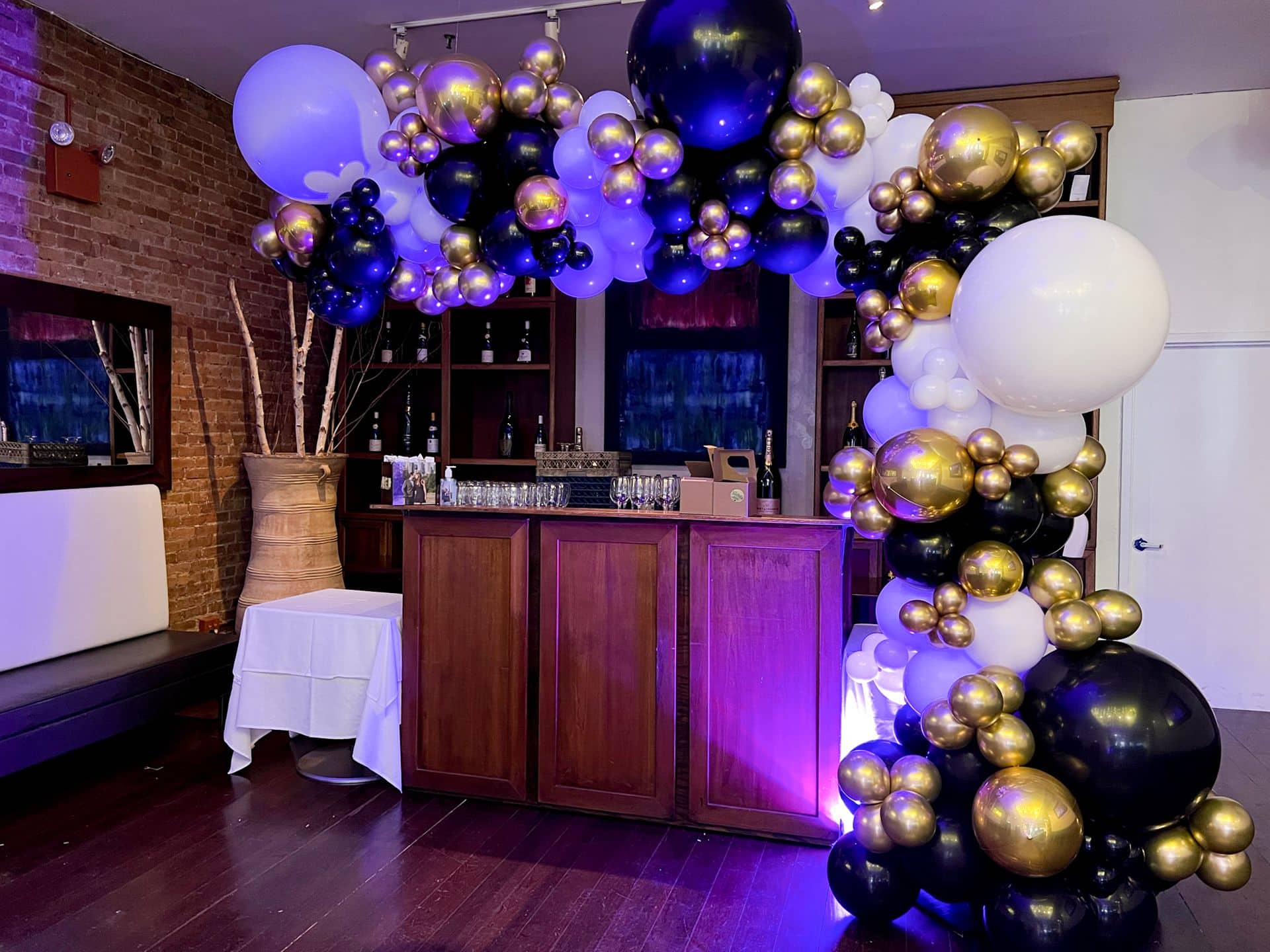 Black, White and Gold Balloon Garland over Bar for Rehearsal Dinner