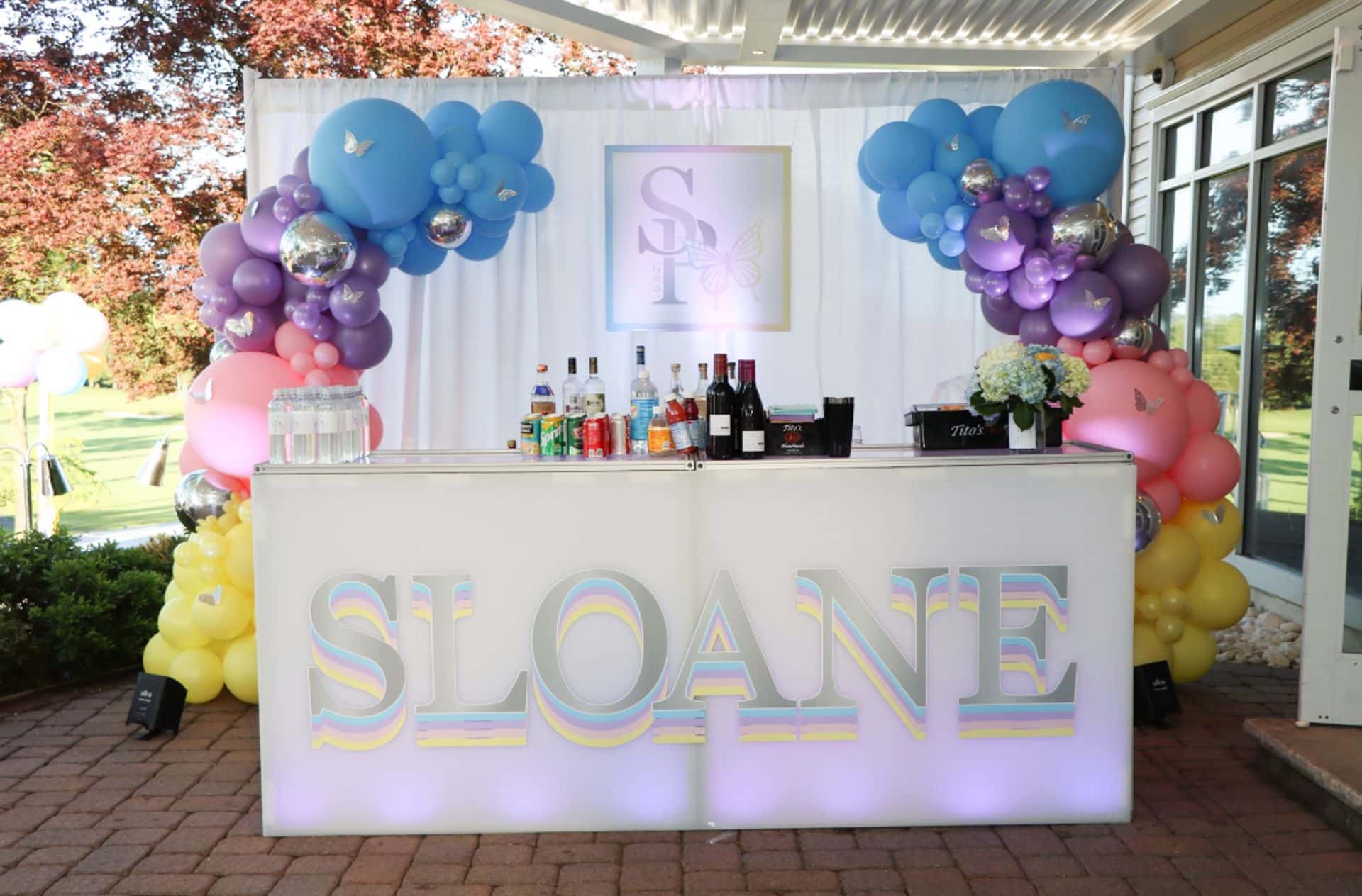 Organic Arch Over Custom Decal Bar with Silver Butterflies for Outdoor Party Decor